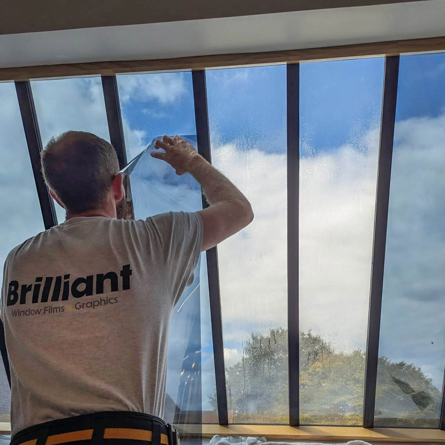 commercial property with window film being fitted by professional installer