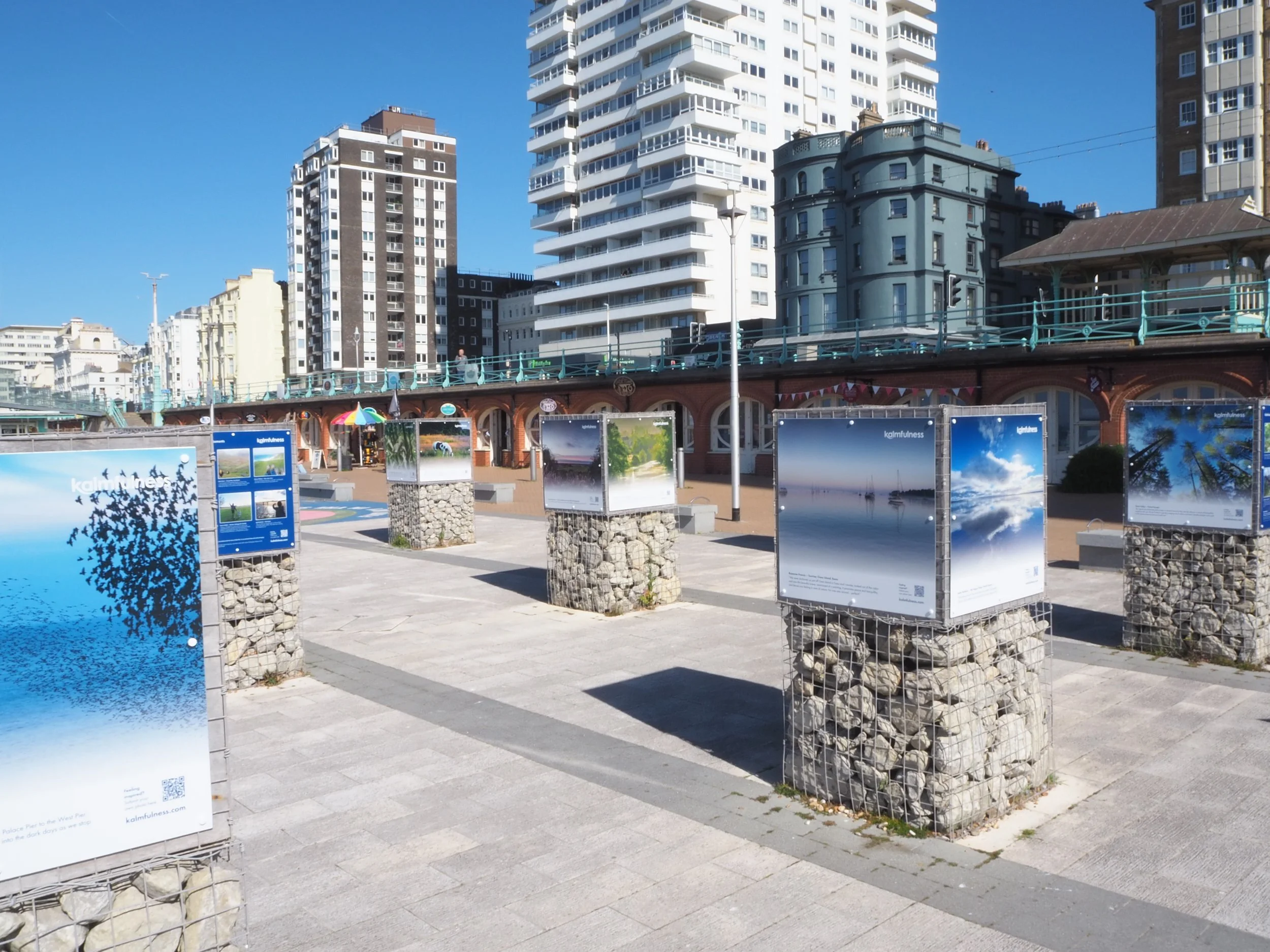 Photos displayed on large structure in a modern pedestrian area of Brighton