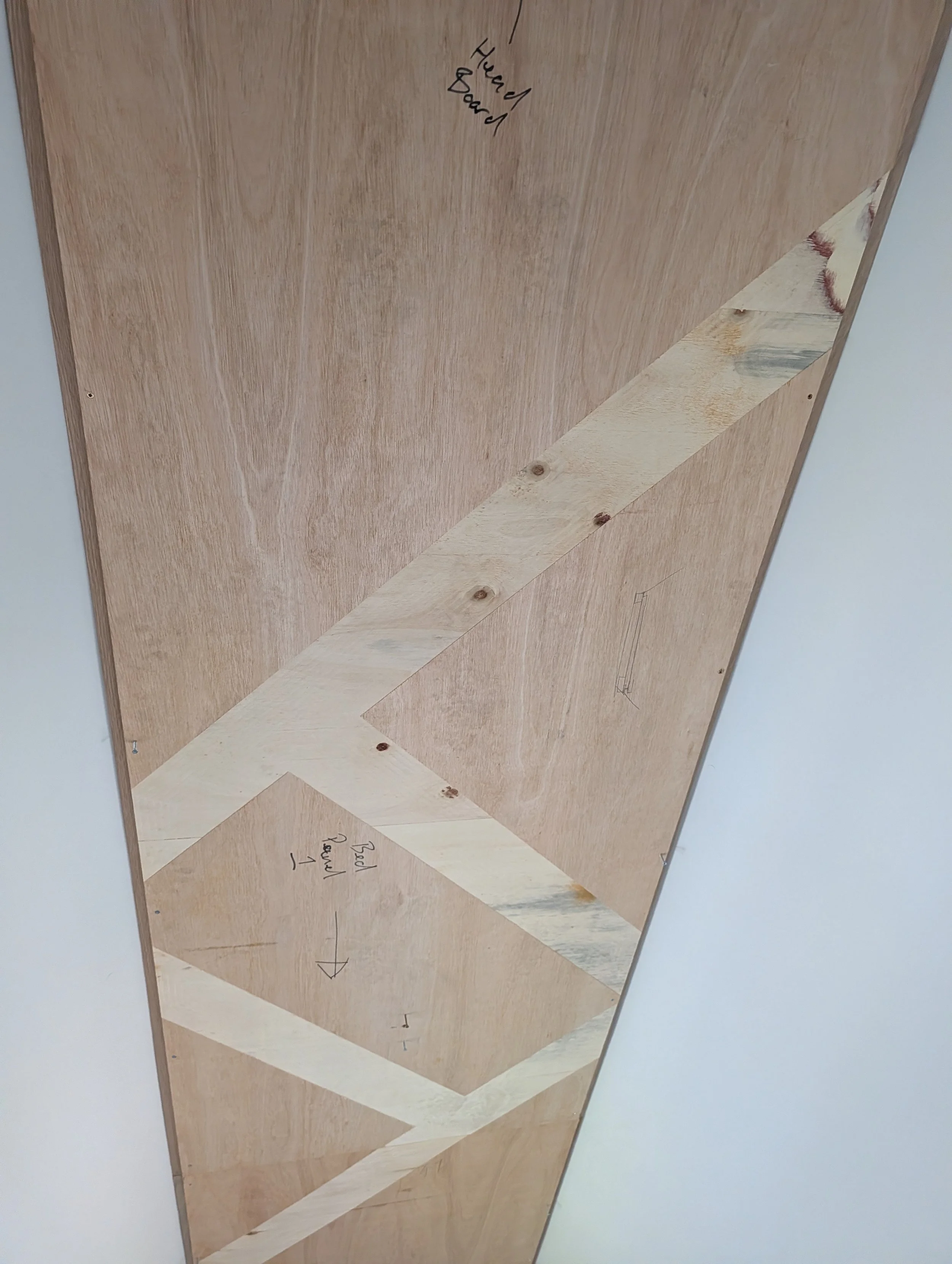 Bespoke geometric timber ceiling with integrated warm lighting by Clark & Prince