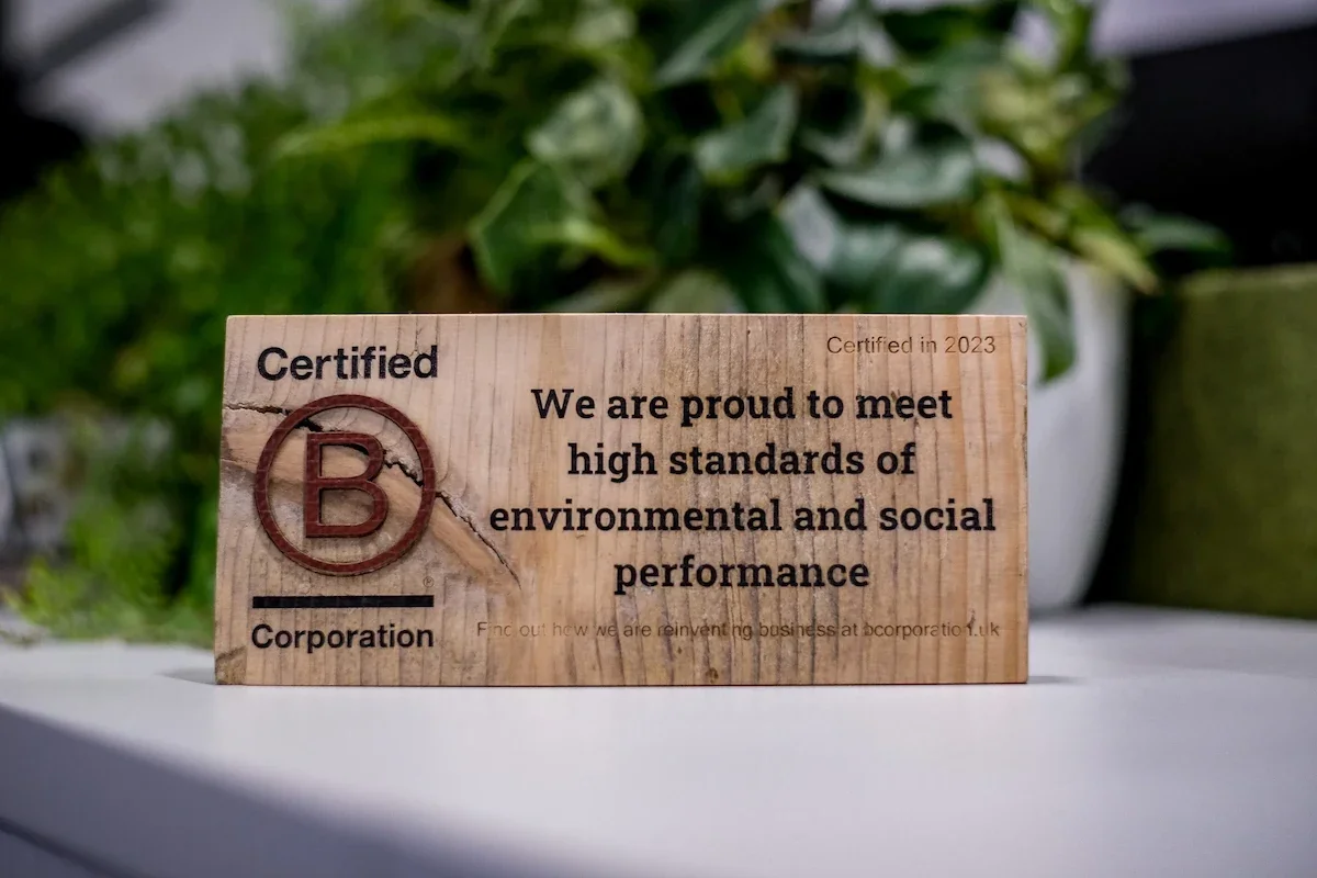 Wooden B Corp Plaque sat in front of