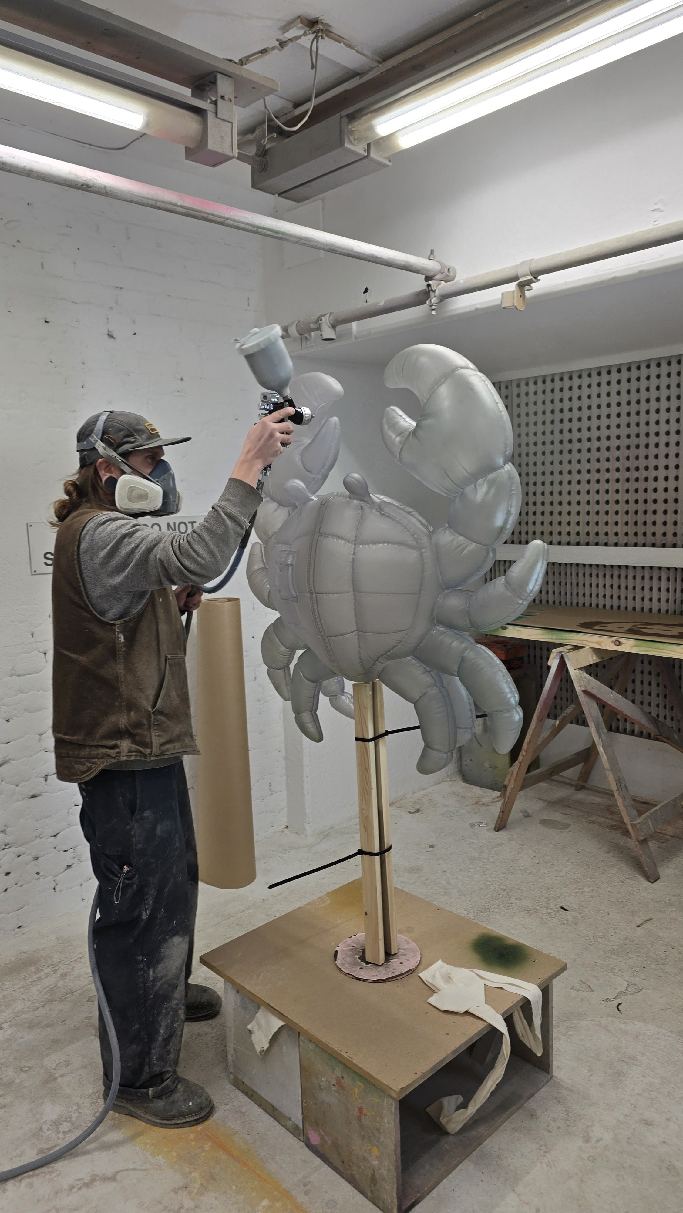 Colour-matched translucent spray finish being applied to the Moncler animal sculpture during fabrication at the Andy Knight workshop.