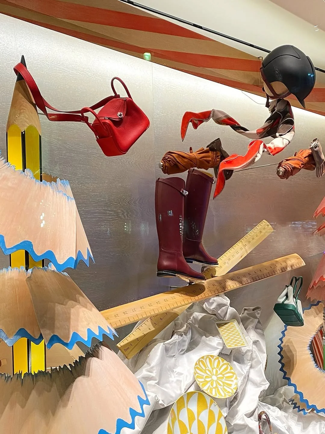 Close up image of the floating products including a skier silhouette in the Christmas window display for Hermès in London, designed by Shona Heath,
