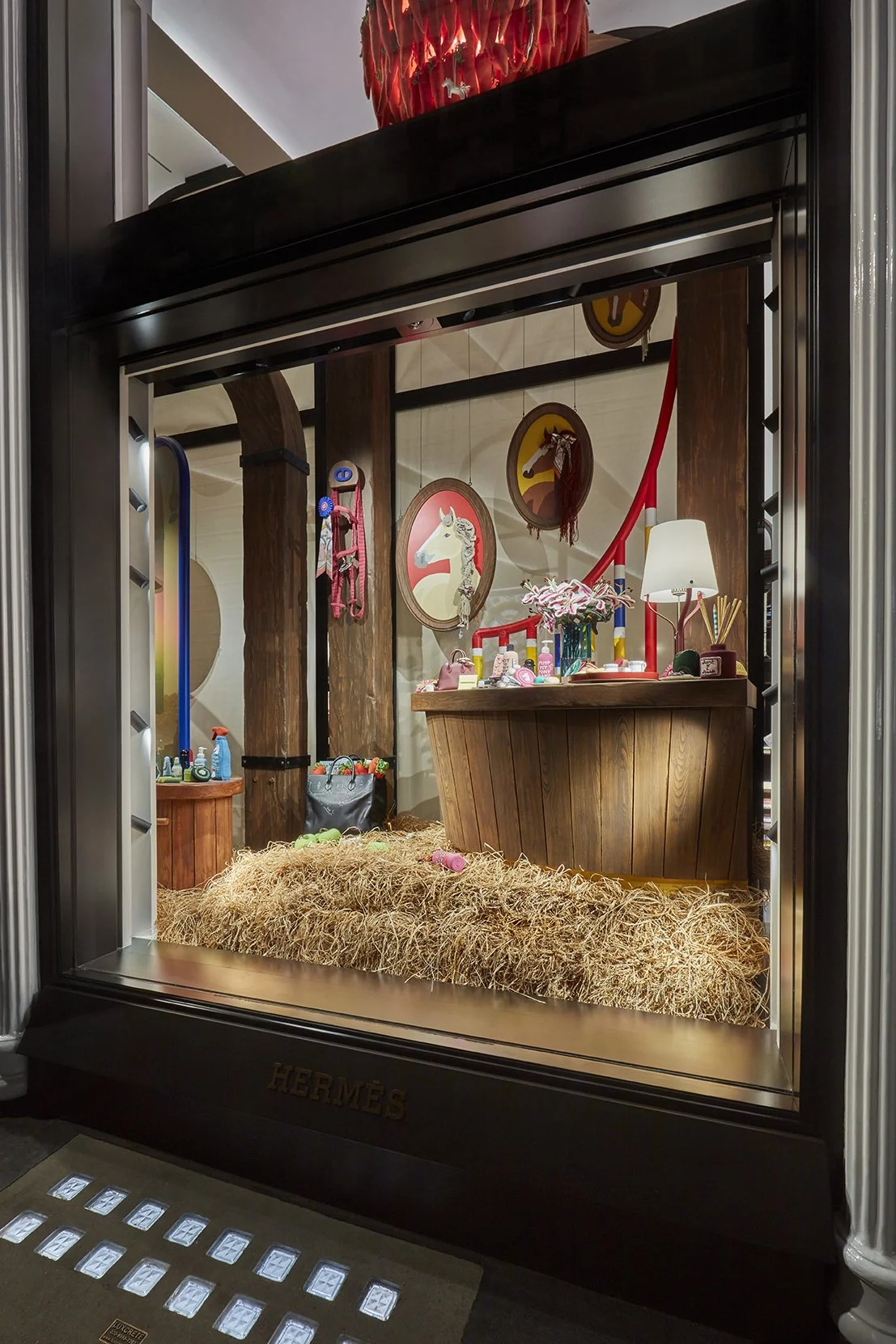 Custom scenic fabrication for Hermès ‘The Rocabarn’, featuring hand-built arches, stable structures and bespoke carpentry finished with an aged timber effect.