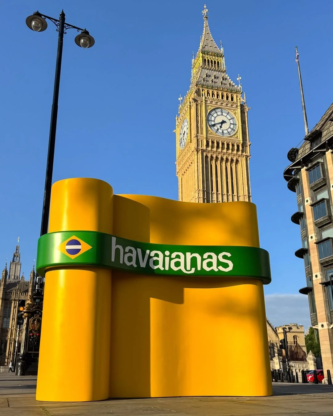 A social image of the custom Branded Havaianas flip flop inspired chair positioned on its side in front of Big Ben 