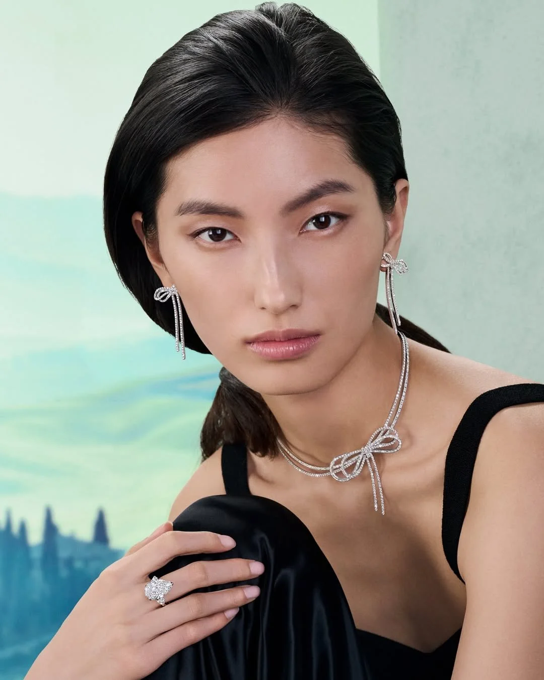Final campaign imagery featuring the completed scenic environment, combining architectural forms, decorative finishes and a printed landscape backdrop to frame the jewellery collection.