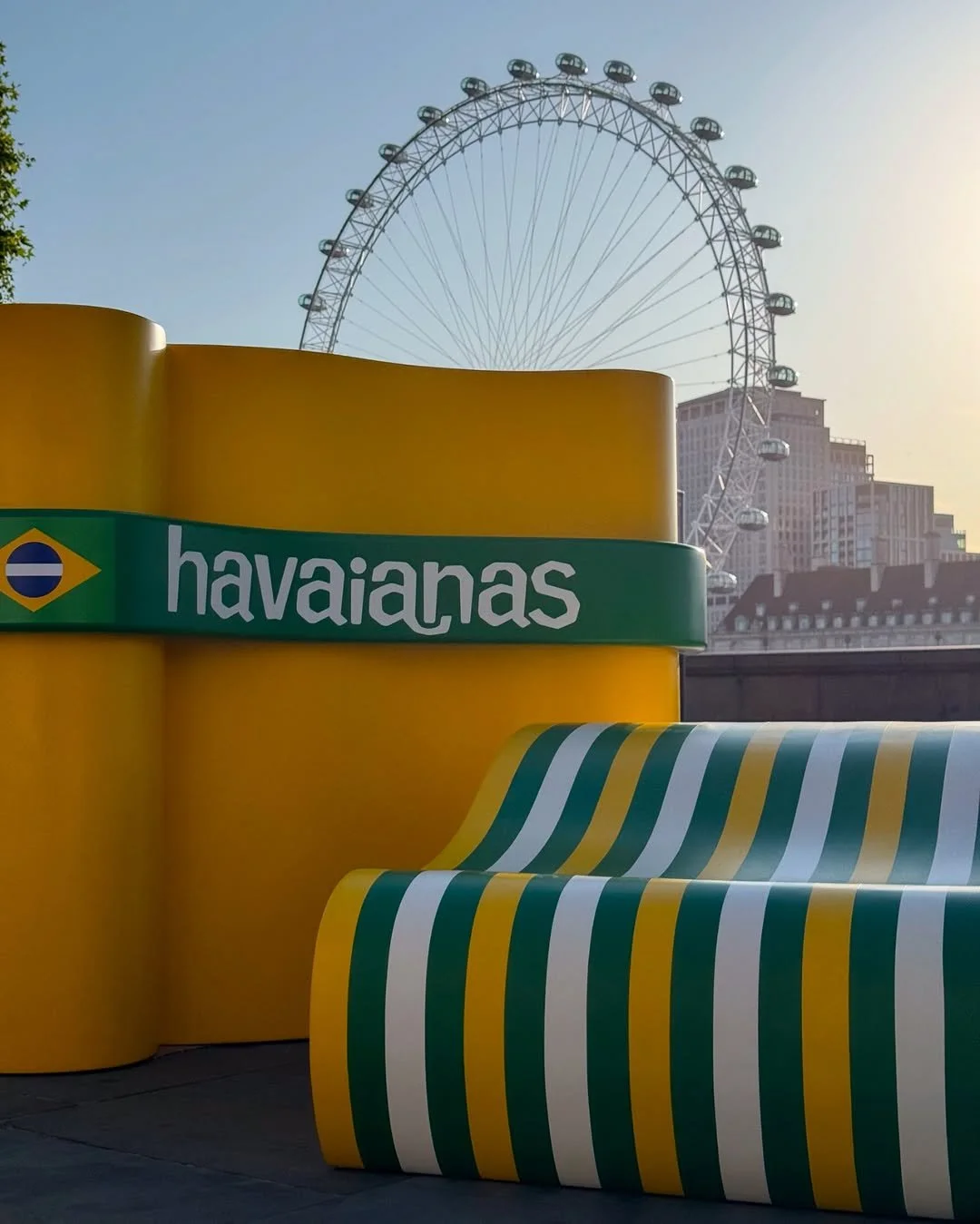 Sunset image of the 2 different styles of flip flop inspired seating that we custom made for Havaianas, they were professionally spray painted in the Brands colours with vinyl logos and branding on top 
