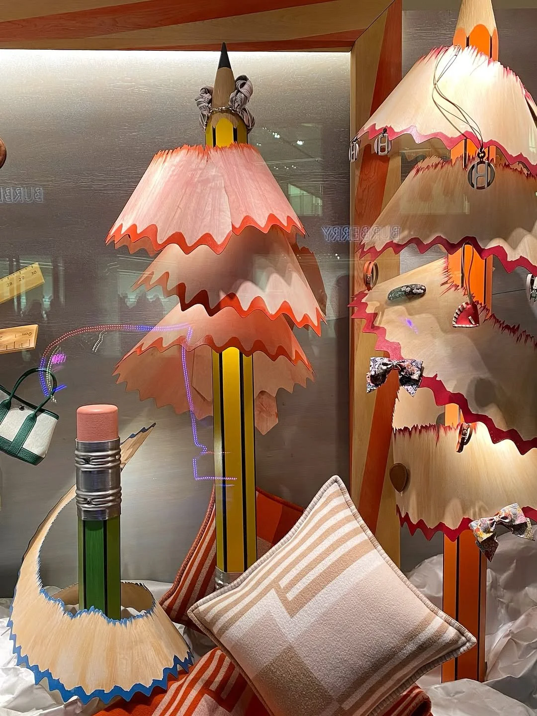 Close up image of the Christmas window display for Hermès in London, designed by Shona Heath, featuring the oversized pencils and wood veneer pencil shavings.