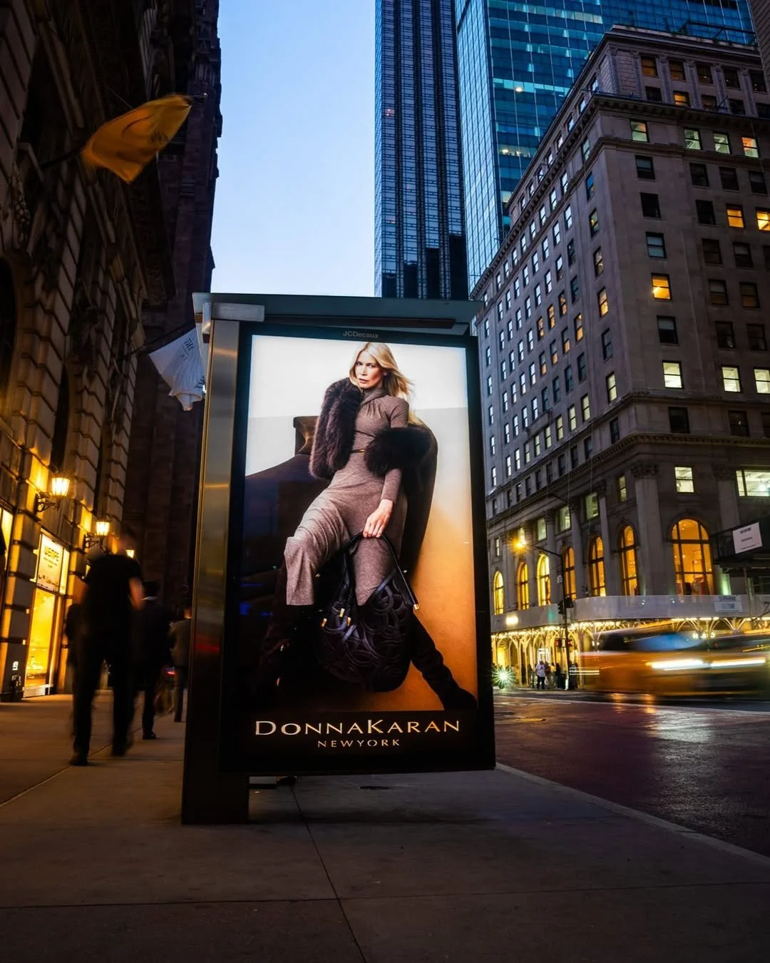 A social image of the Donna Karen shoot image being displayed on a bus stop billboard in the USA