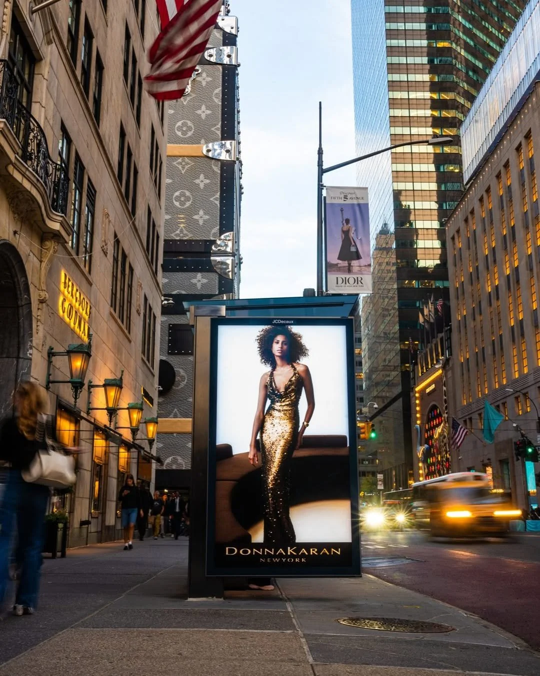 Another social bus stop billboard image of the Donna Karen Fall 25 editorial shoot featuring the set and custom sofa we made 