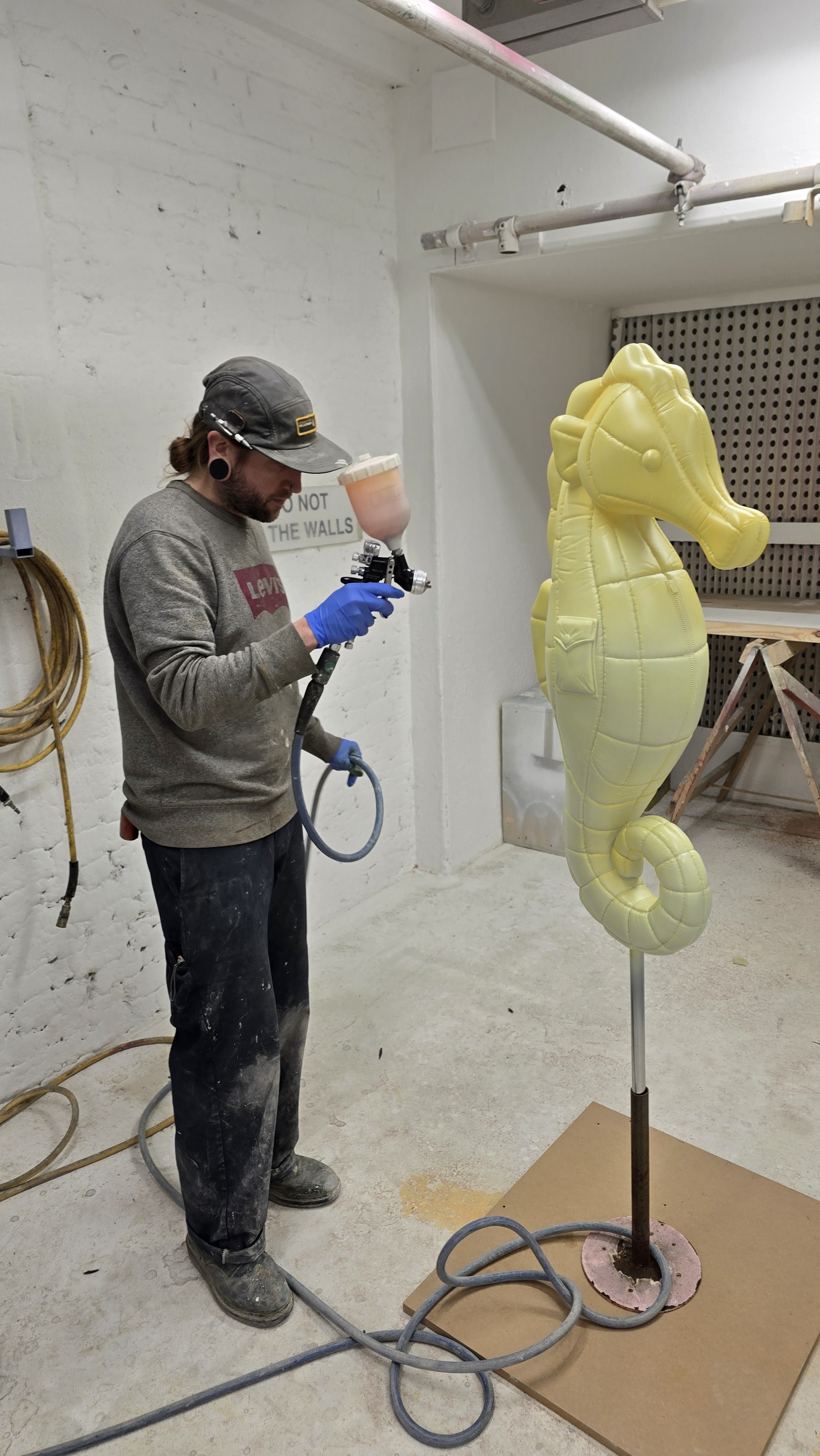 Large-scale Moncler sculpture being spray finished with a custom colour-matched semi-transparent coating while retaining the translucency of the material.