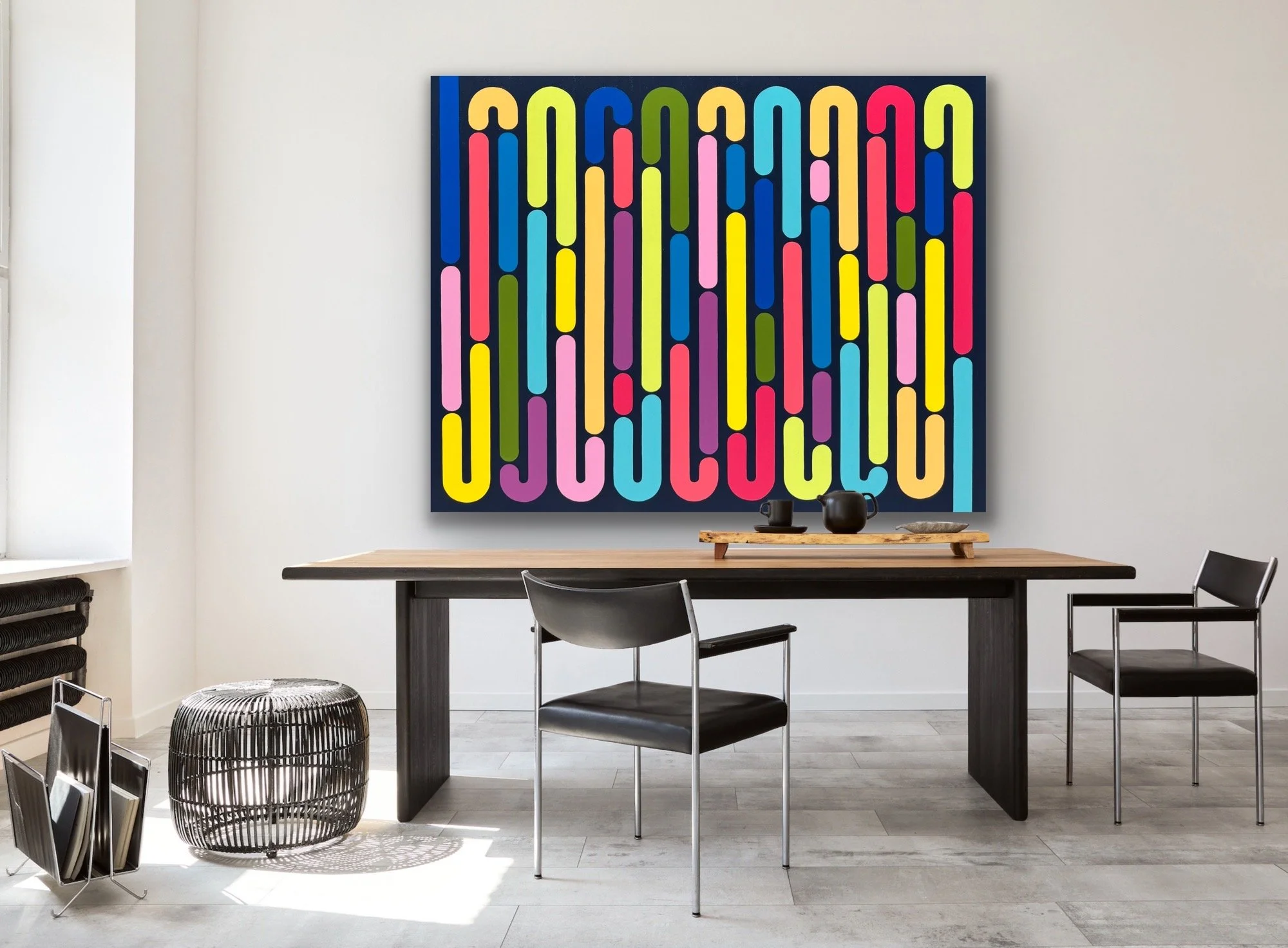 Contemporary geometric abstract artwork from the Momentum collection by Merrill Moore shown in a modern interior setting. Bold color, repeating elongated forms, and rhythmic movement create a dynamic focal point while reflecting the constant transiti