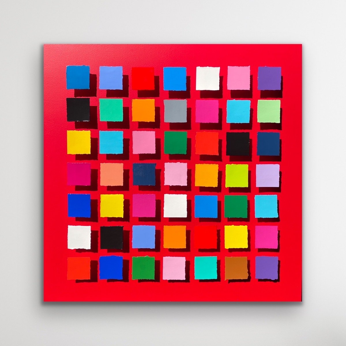 Geometric abstract artwork from the Structure + Shift collection by Merrill Moore. Hand-painted paper fragments are arranged in a structured grid across a vivid red background, creating a dynamic interplay between precision and variation. Subtle shif