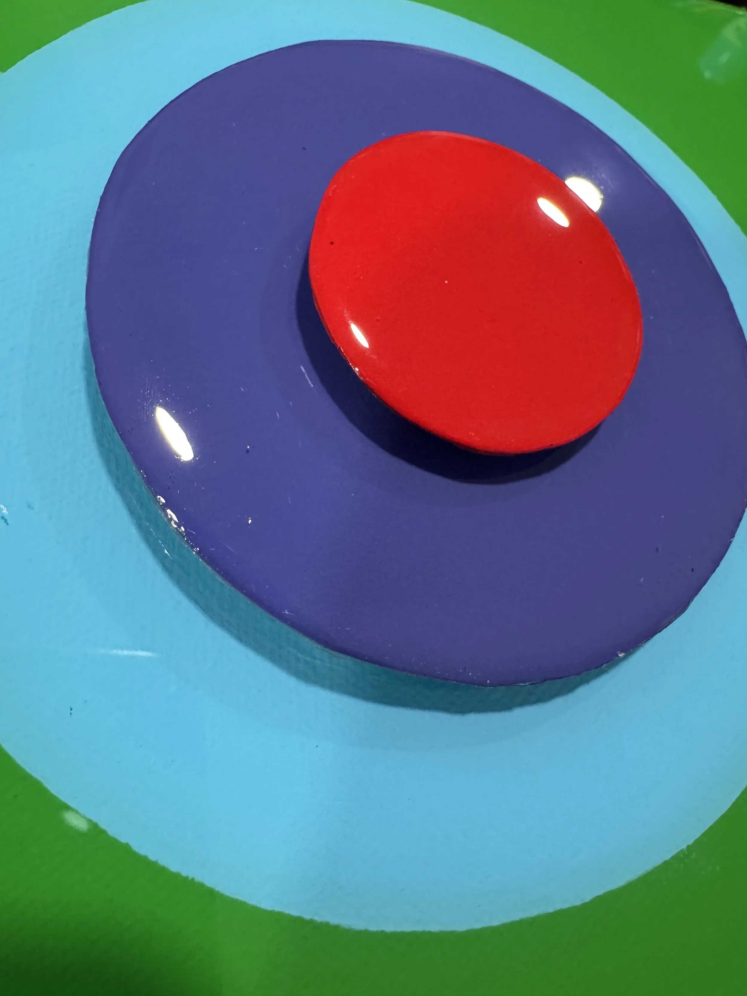 These small-scale Taking Aim pieces combine bold geometric compositions with layered dimensional elements and high-gloss resin surfaces. Exploring focus, direction, and personal momentum, each work uses vibrant color relationships and reflective fini