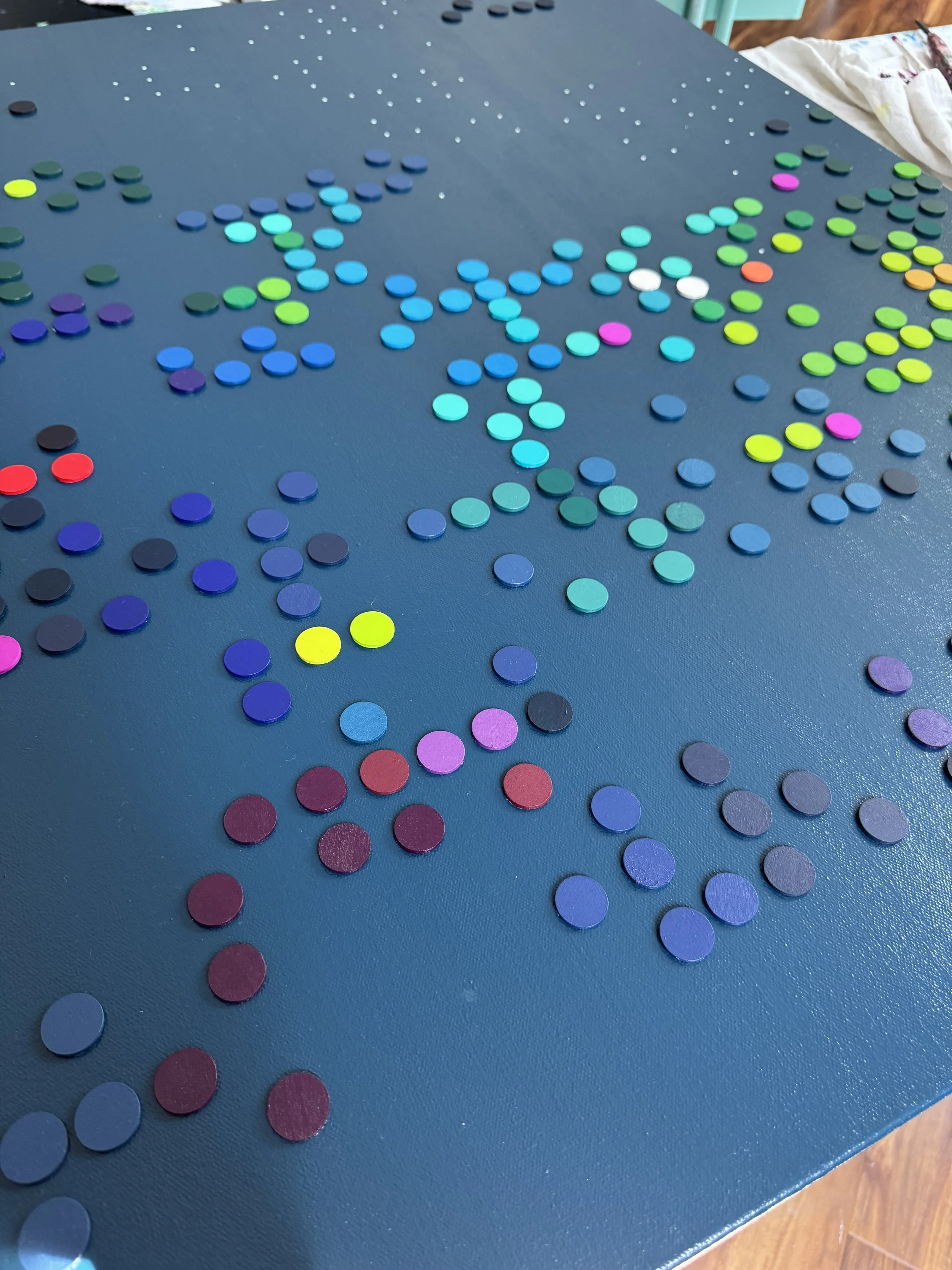 Hand painted wooden disc close up. 