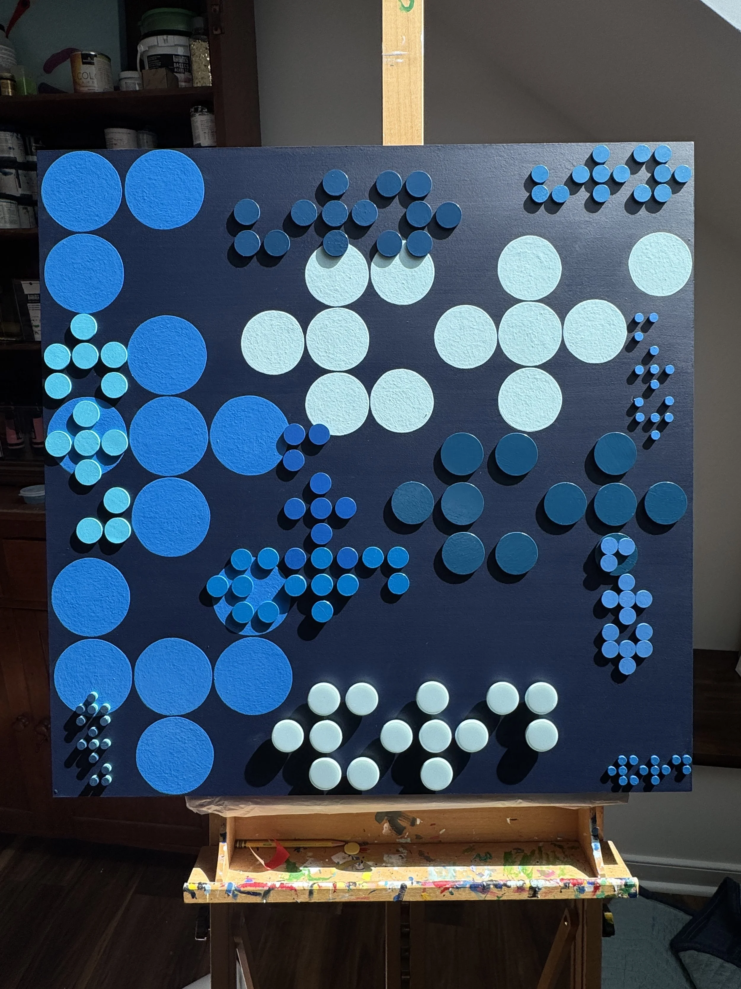 A contemporary abstract Braille artwork exploring the power and repetition of language through layered geometric forms in varying shades of blue. Repeating the word “WORD” in Braille, the piece examines how language overlaps, rises, fades, and shapes