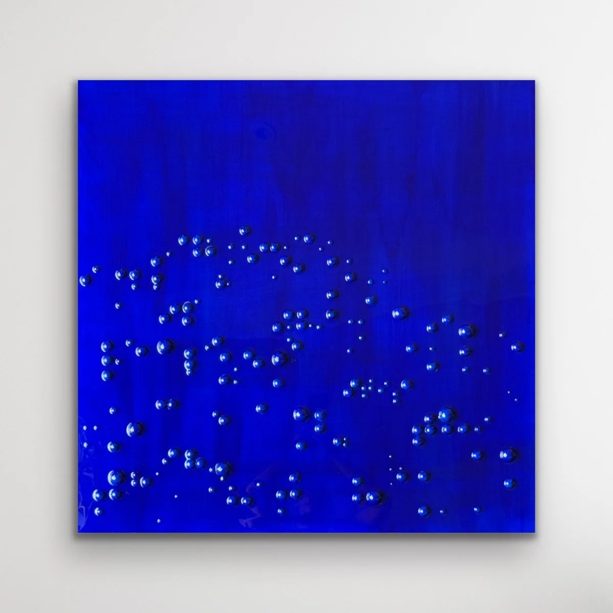 Ultramarine blue abstract artwork with raised Braille-inspired forms and glossy resin surface by Merrill Moore