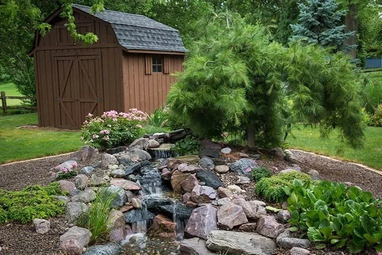 medium pondless waterfall in backyard area