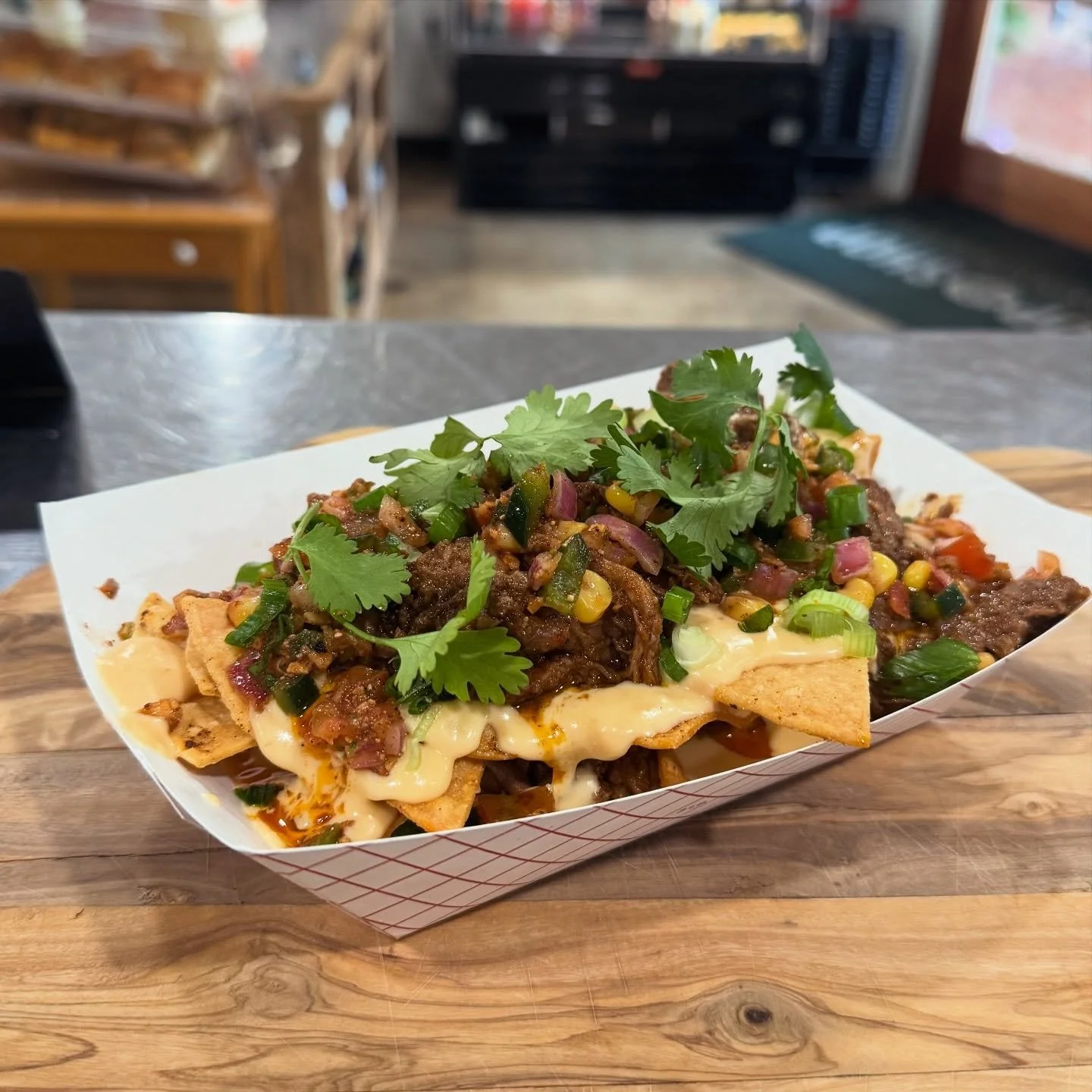 Nacho average lunch, folks! 

Our Guisado Brisket Nachos start with a healthy serving of beef tallow fried corn chips, then get loaded up with queso, ancho mole braised brisket, chili corn pico, and a hit of fresh cilantro.

Come hungry, pard! 

#cho