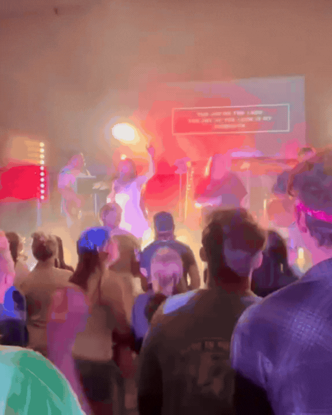 From above hands of unrecognizable woman rubbing aromatic spices into piece of raw meat over parchment paper