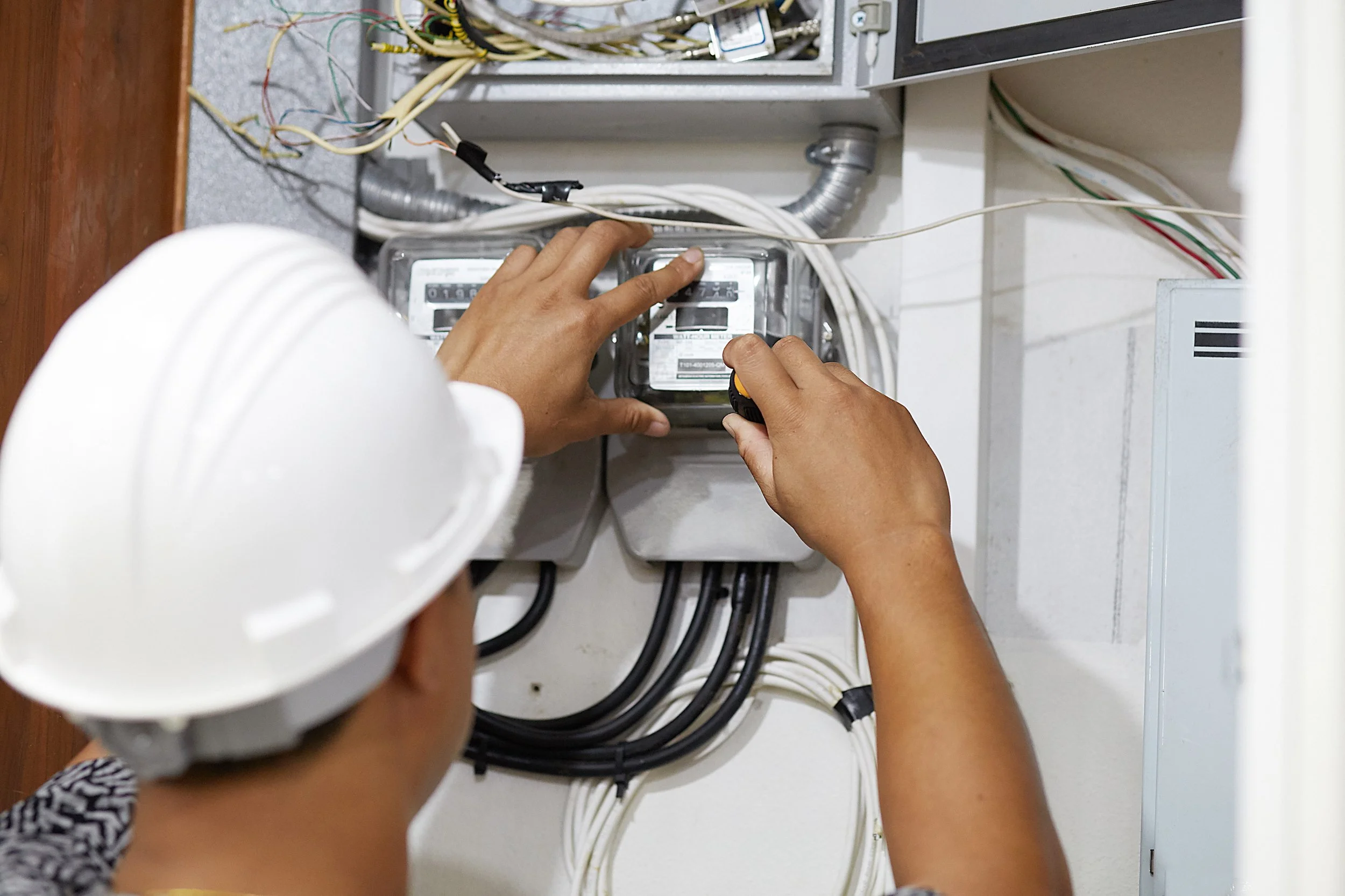 Certified technician installing utility submeters in a commercial property