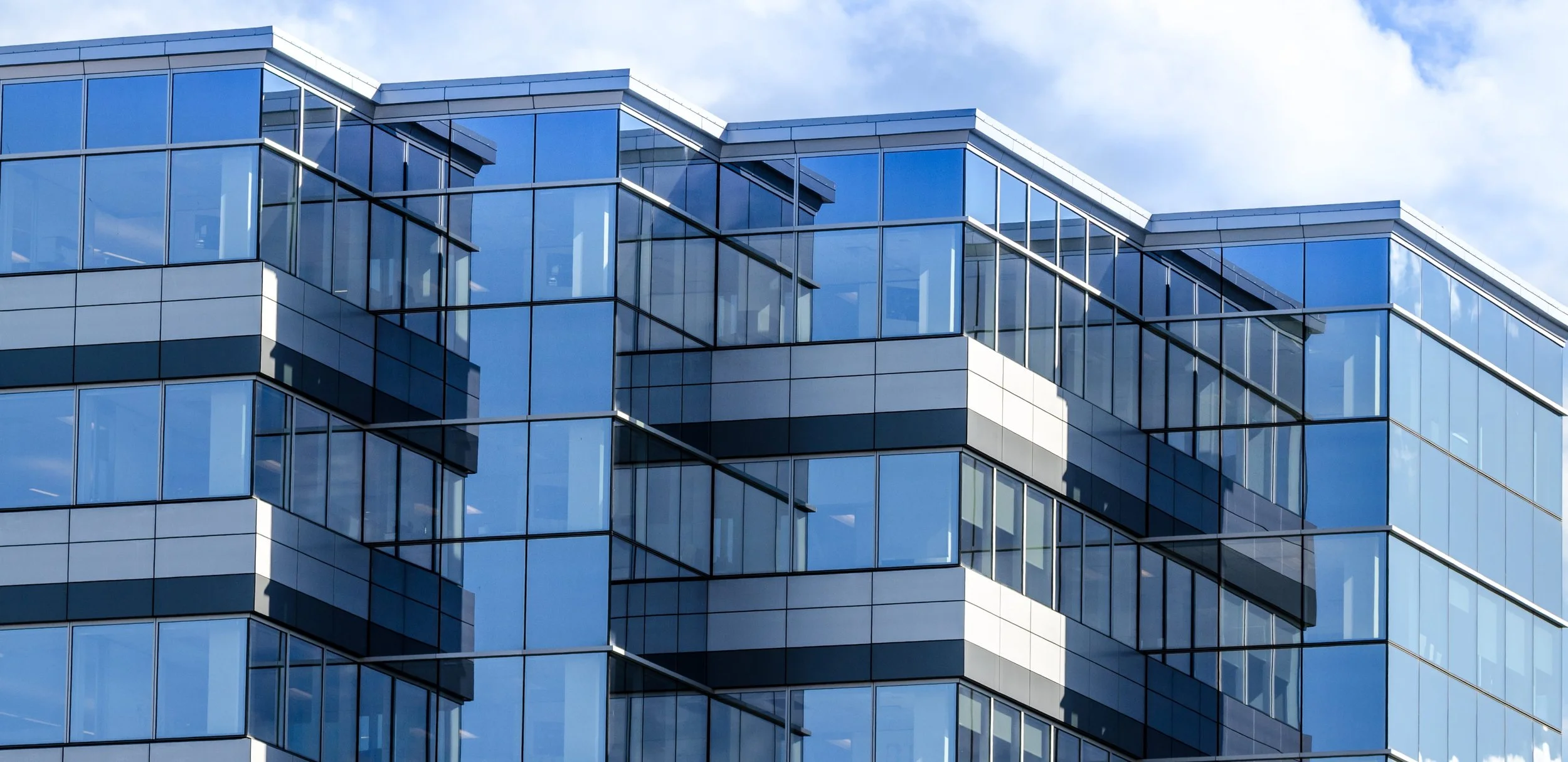 Modern commercial office building exterior representing properties that benefit from professional water meter installation