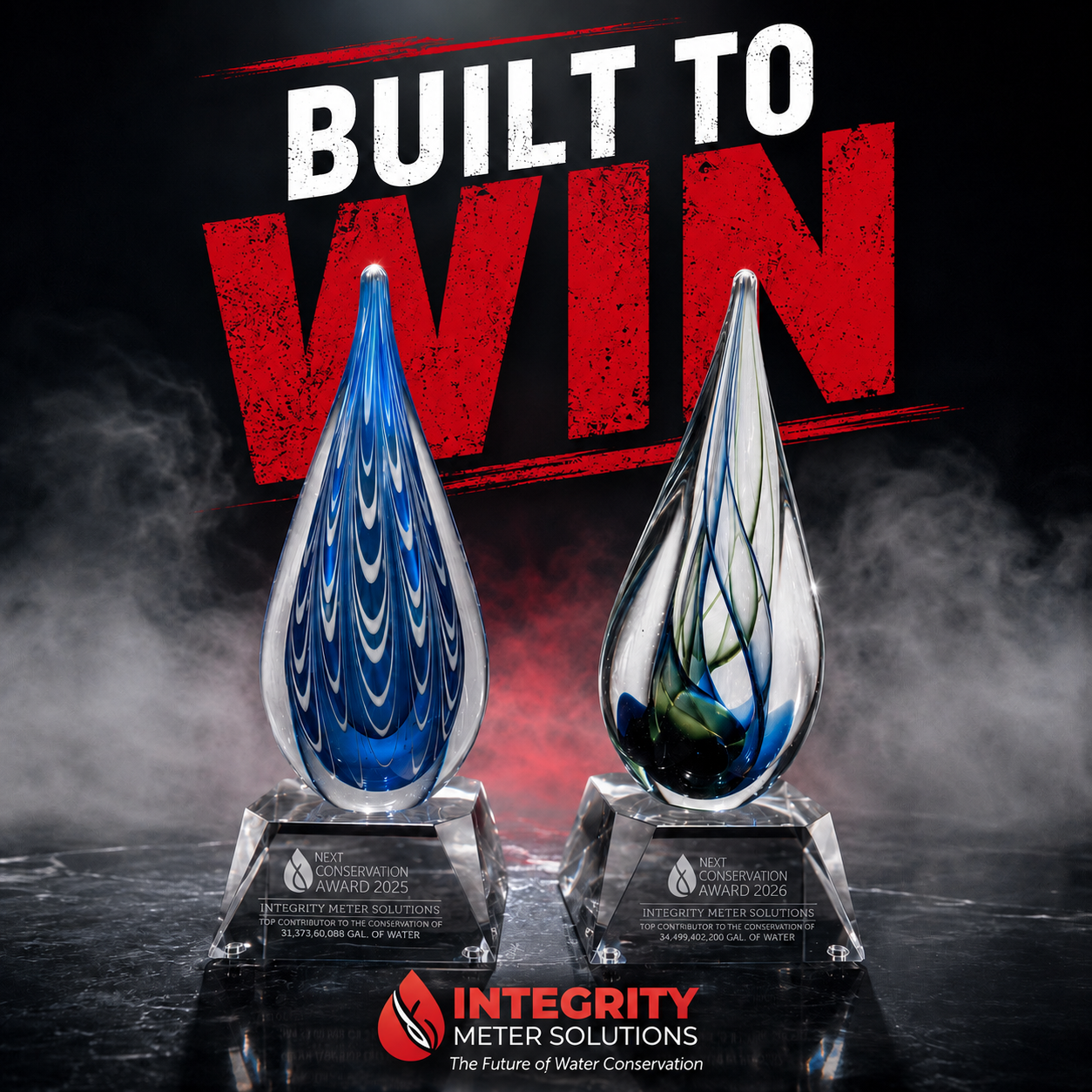 Two glass awards from Integrity Meter Solutions with the text "Next Conservation Award 2025" and "Next Conservation Award 2026." The awards are teardrop shaped with blue and white swirls, placed on black bases. Behind them is a background with the words "Built to Win" in bold red and white letters.