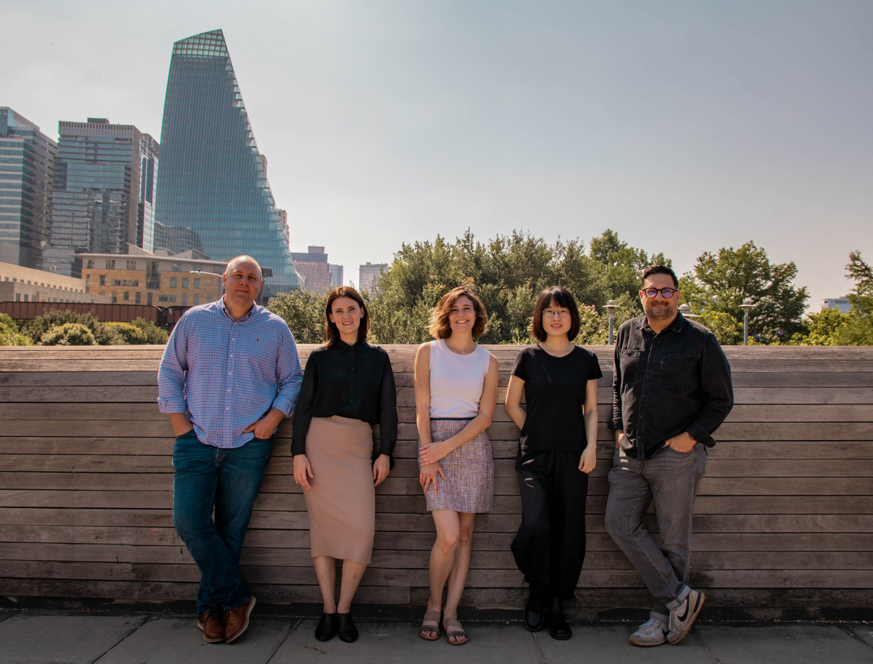 Oro Design Group Studio Staff - Jason Nobbe, Keely Rizzato, Courtney Tarver, Haoting Li, and Alex Howell. Pfluger Pedestrian Bridge over Lady Bird Lake in Austin, TX. Austin skyline.
