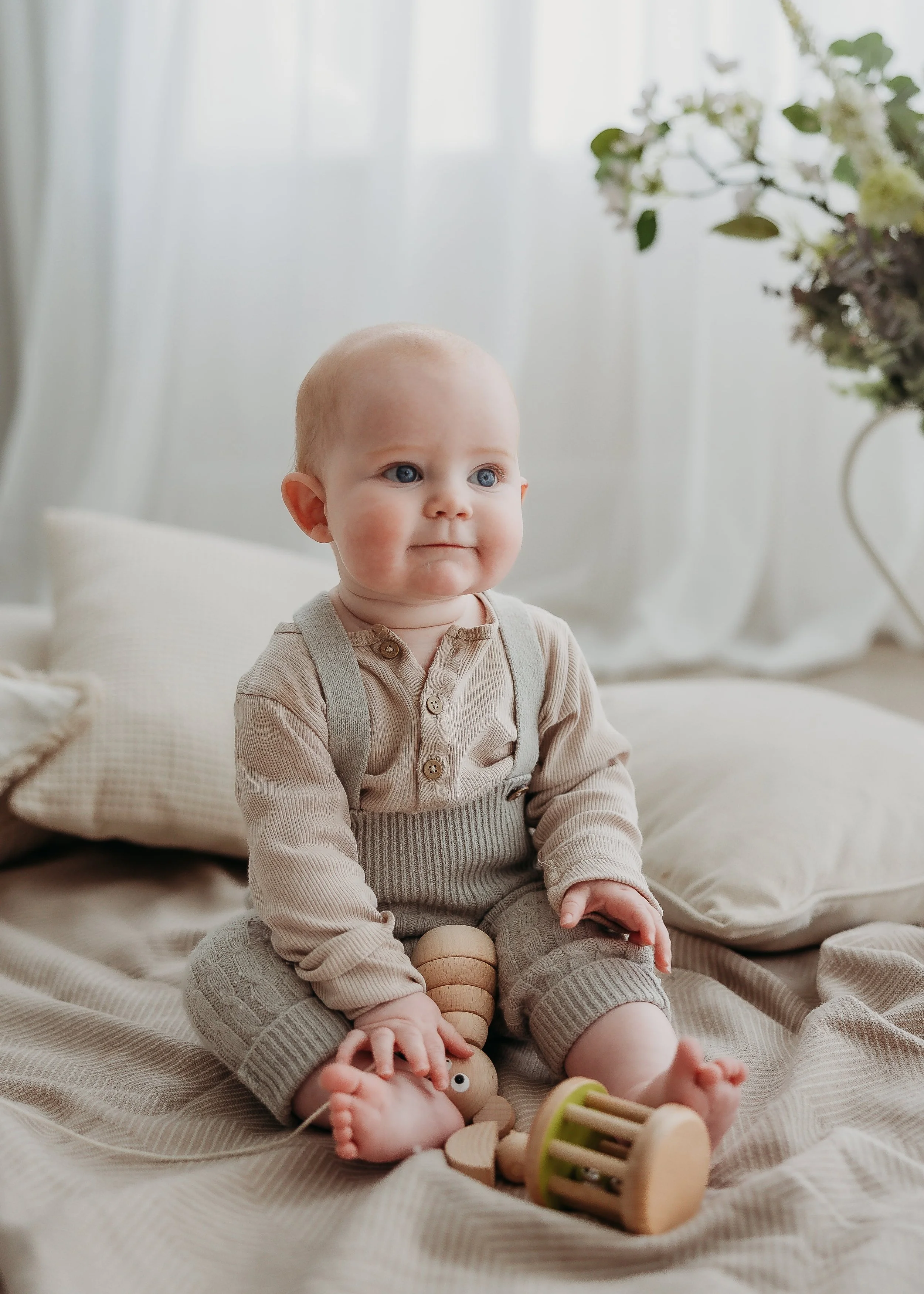 Happy toddler playing with wooden toys during a relaxed studio session near Burton