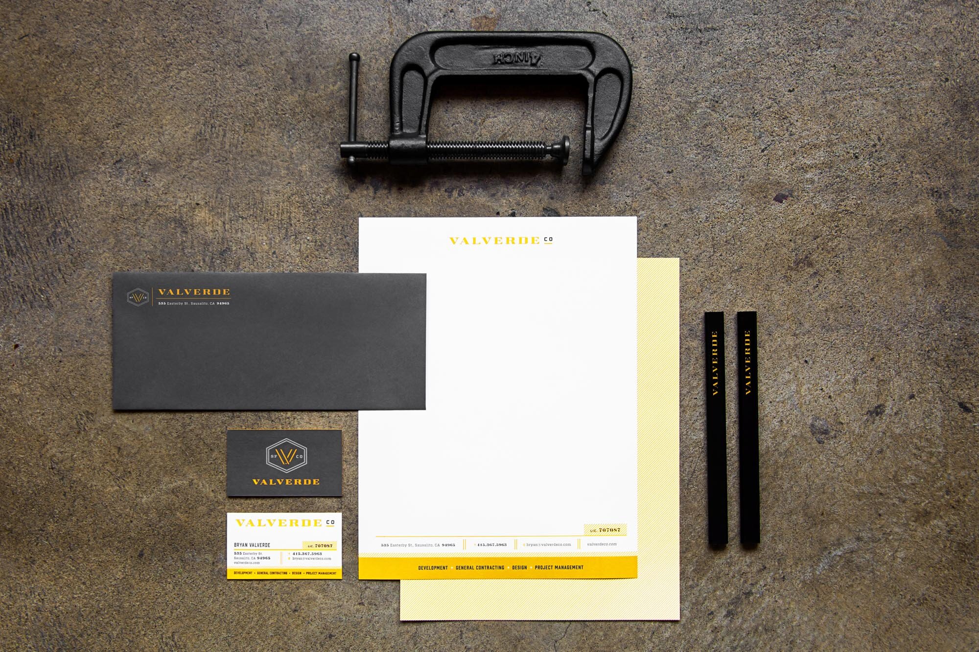 Multiple types of stationary with Valverde Construction branding on a flat brown surface