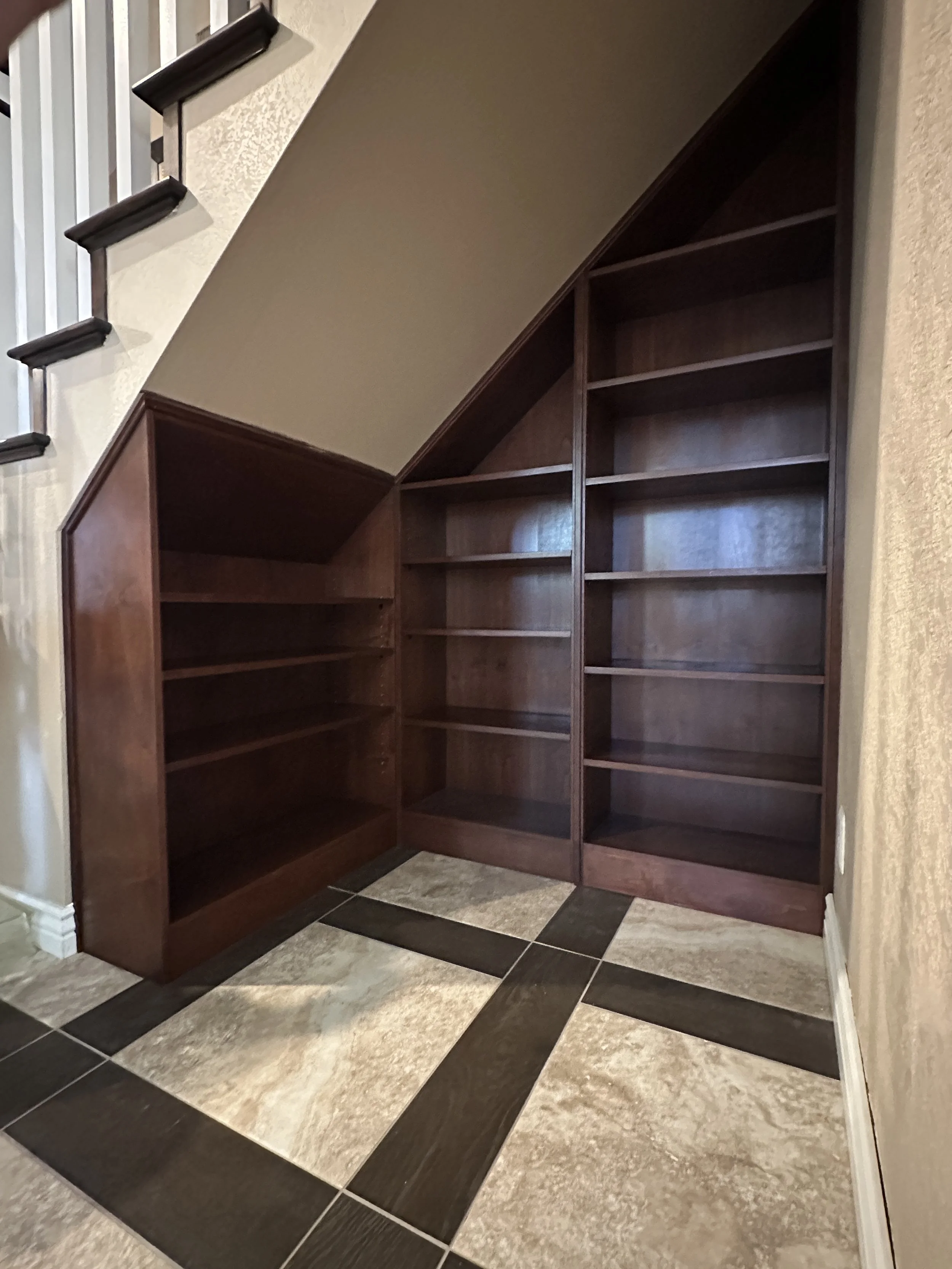 handmade bookcase, alder wood. constructed to fit perfectly in stair case nook