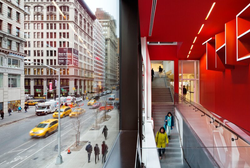 Split view of a Fifth Avenue street scene and the red stairwell inside The New School University Center in New York City