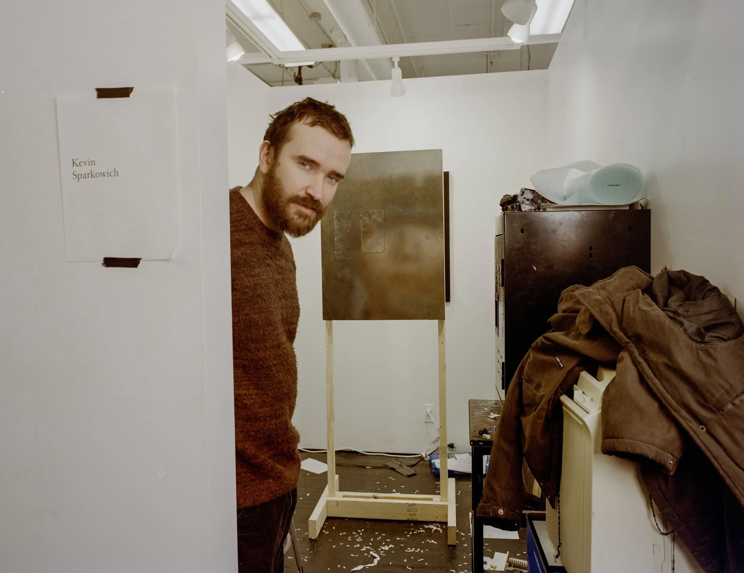 Marine veteran and Parsons artist Kevin Sparkowich in his studio with his artwork