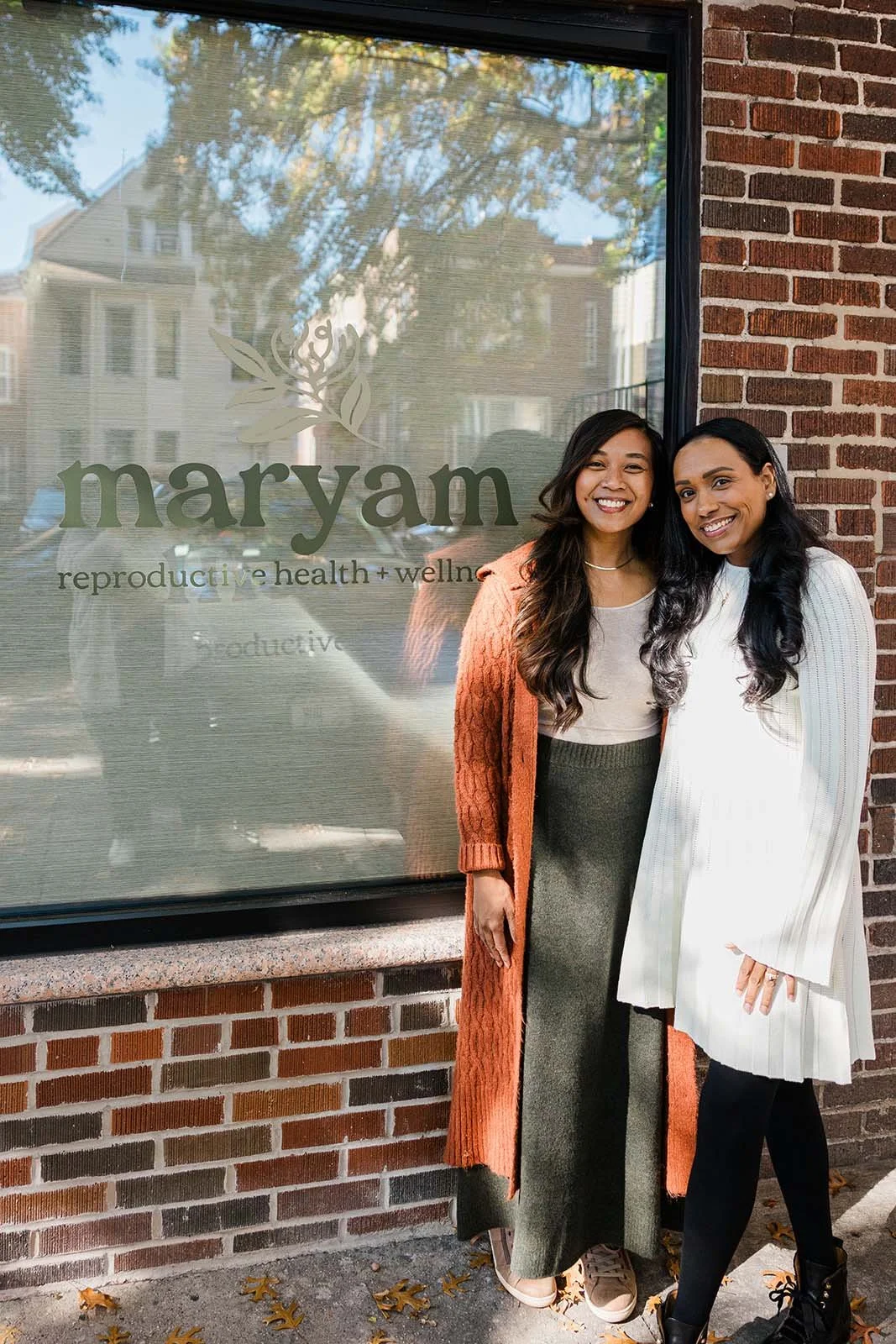 Carla and Myla smiling in front of Maryam Reproductive Health + Wellness
