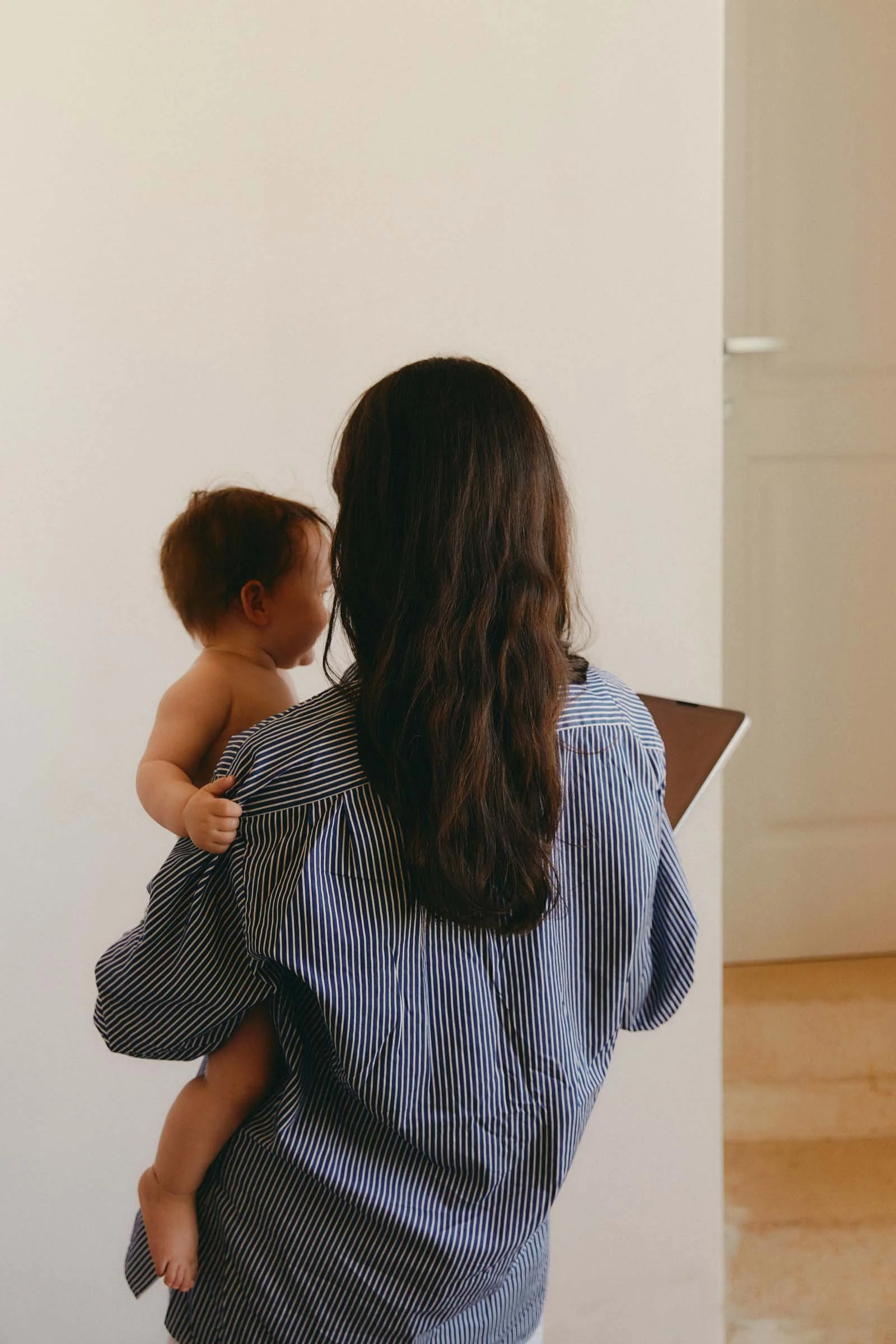 Mother holding her baby during the postpartum period after personalized pregnancy and birth planning care.
