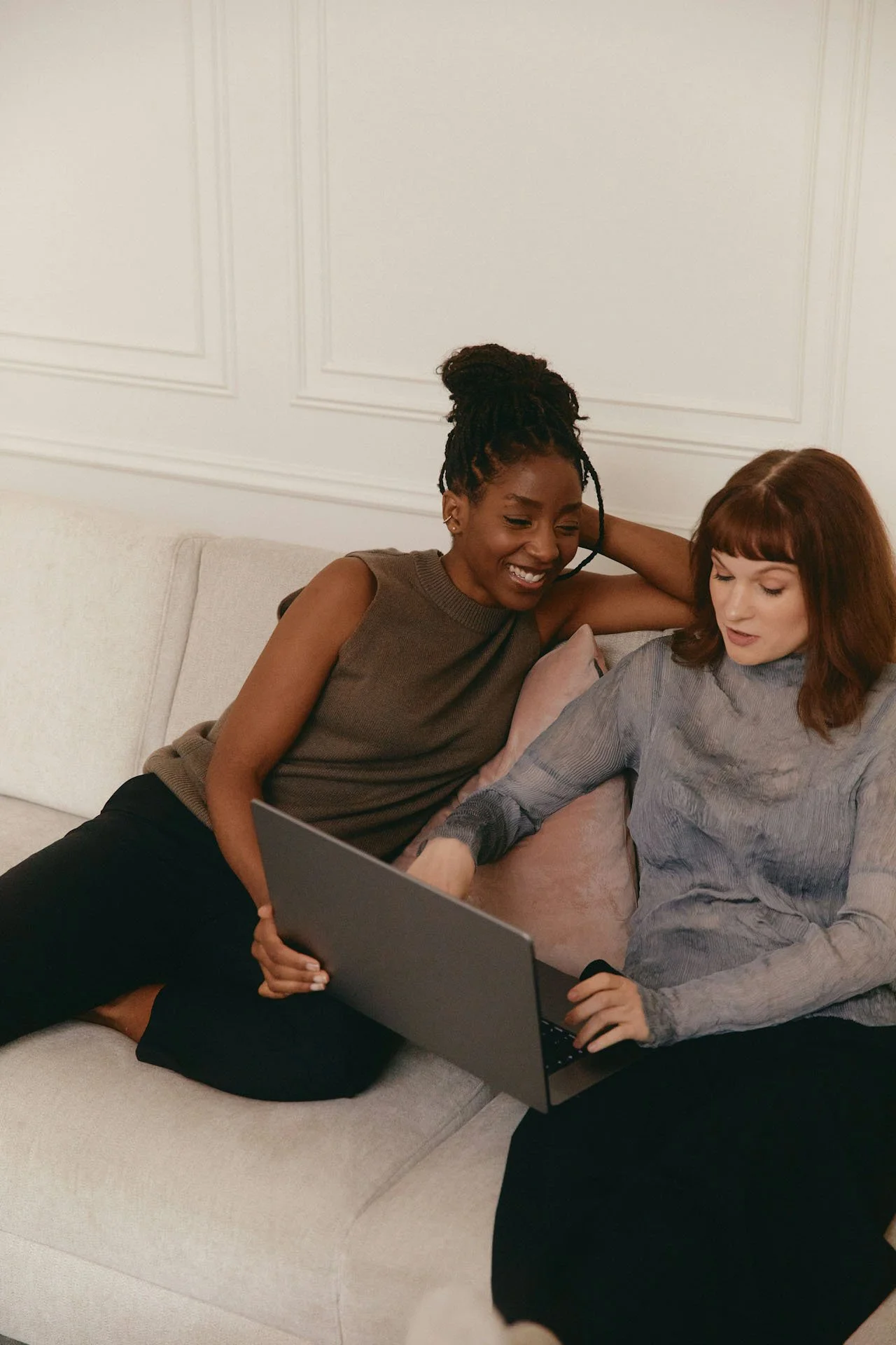 Two women reviewing care information together on a laptop, reflecting the personalized, collaborative care journey at Maryam Reproductive Health + Wellness from consultation through ongoing support.