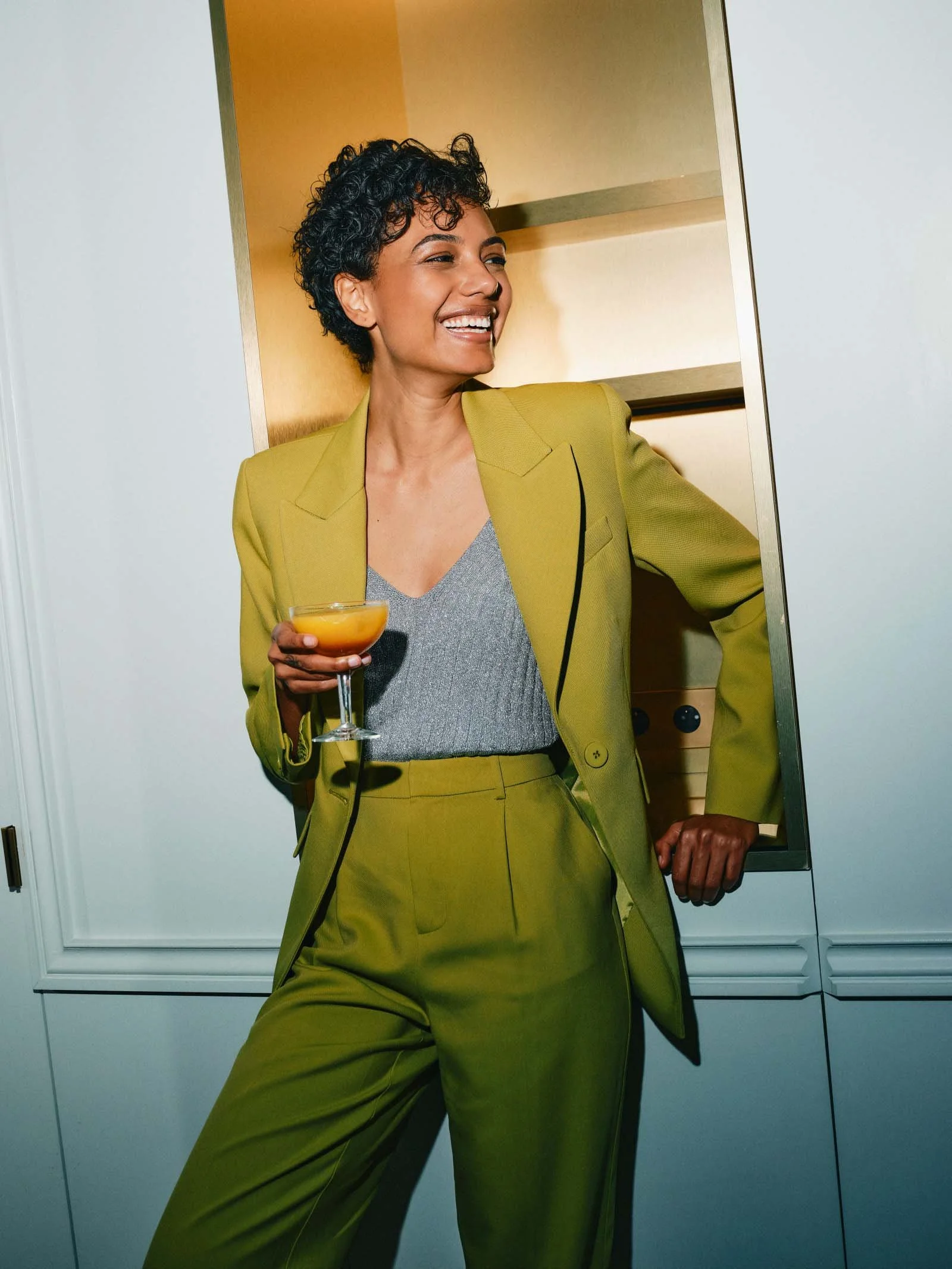 Woman smiling in a welcoming healthcare setting, reflecting Maryam's personalized, relationship-centered reproductive healthcare for women in the Bronx.