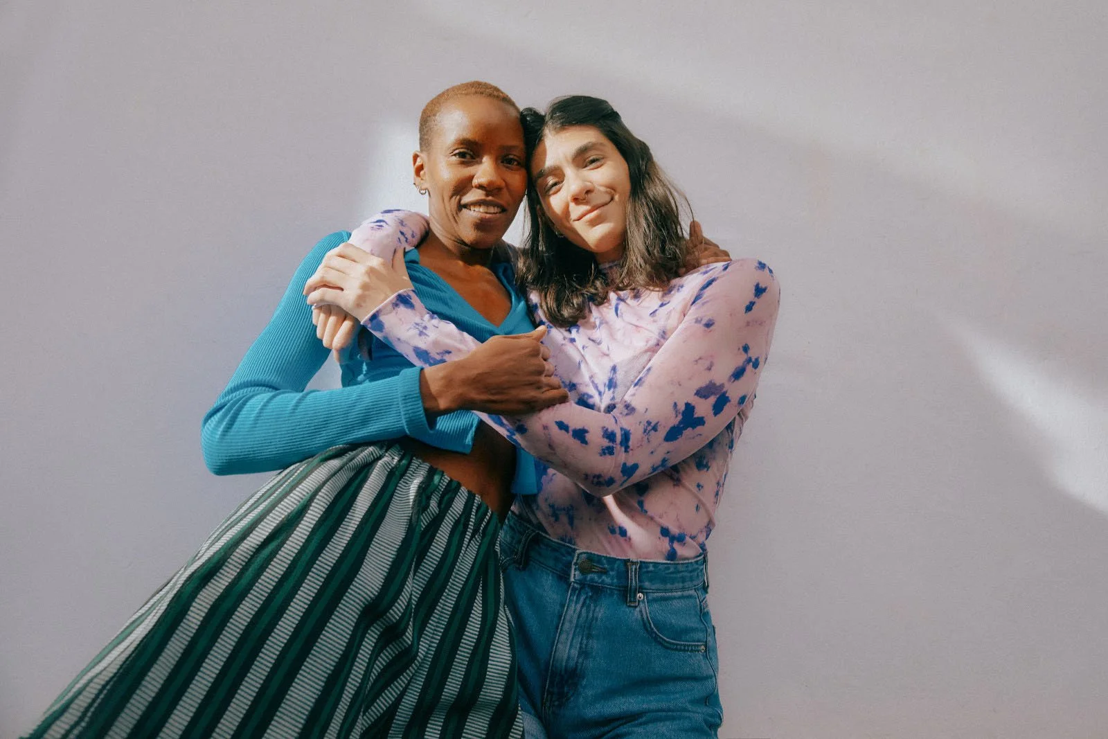 Two women embracing while celebrating lifelong wellness and preventive gynecologic care.