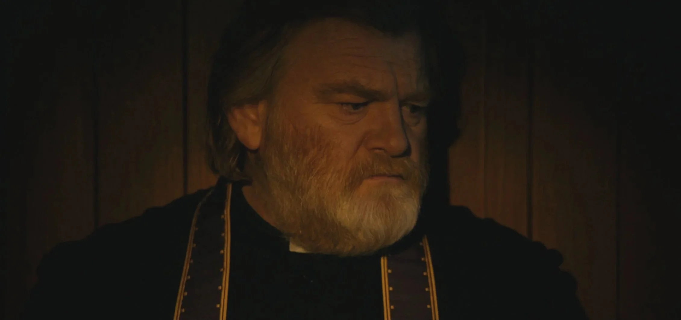 Still from the film Calvary with an older man with a beard wearing priest garb