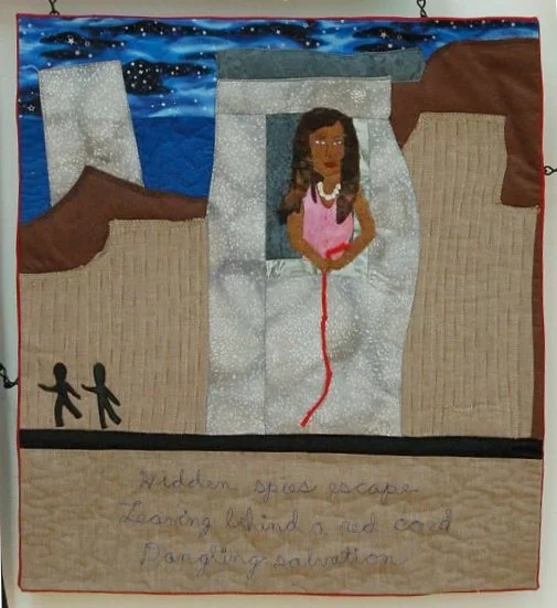 A quilted artwork depicting a girl lying in a hospital bed with brown and beige walls, a night sky background, and two black figures holding hands. Handwritten text at the bottom reads, 'Hidden spies escape landing behind a red cord. Daring salvation.'