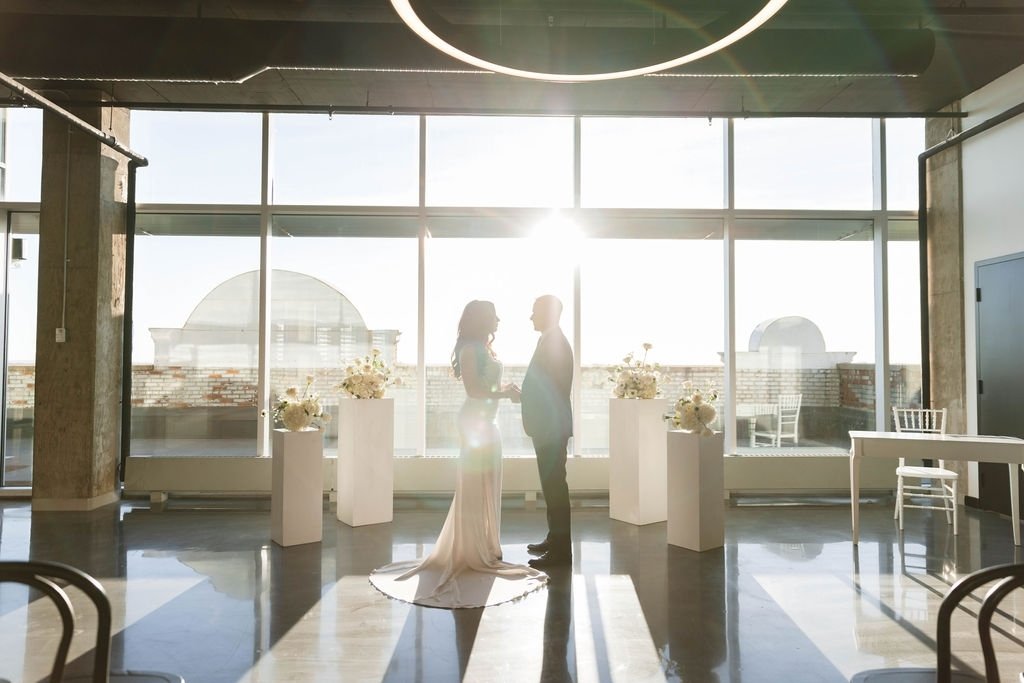 What a perfect shot! These elegant white podiums create such a beautiful modern altar. We take care of set-up and tear-down so you can enjoy every moment of your special day with friends and family in the heart of the city. 
.
.
#yegweddingvenue #yeg