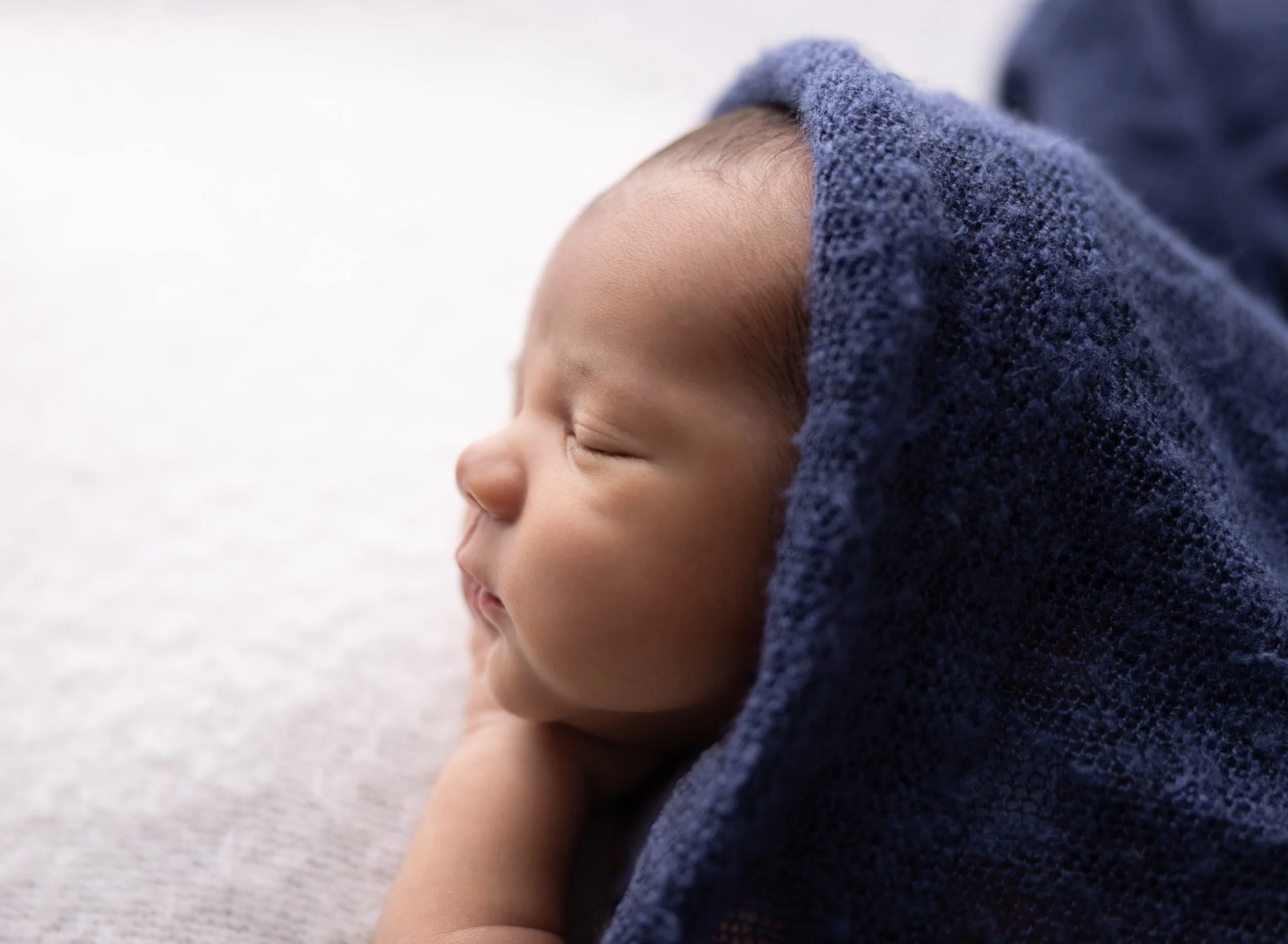 Newborn boy backlit on white in Fort Myers FL