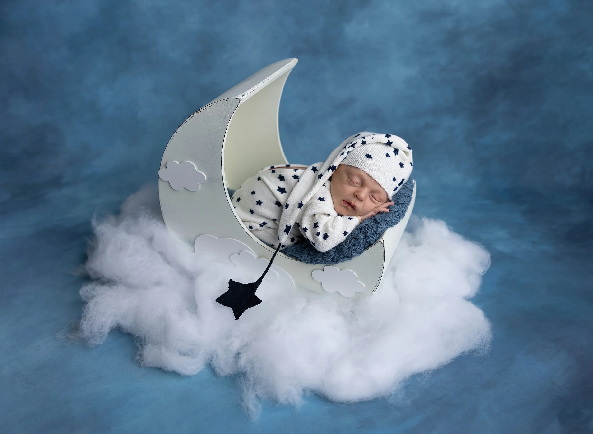 Newborn baby in moon prop with stars Lakewood Ranch FL