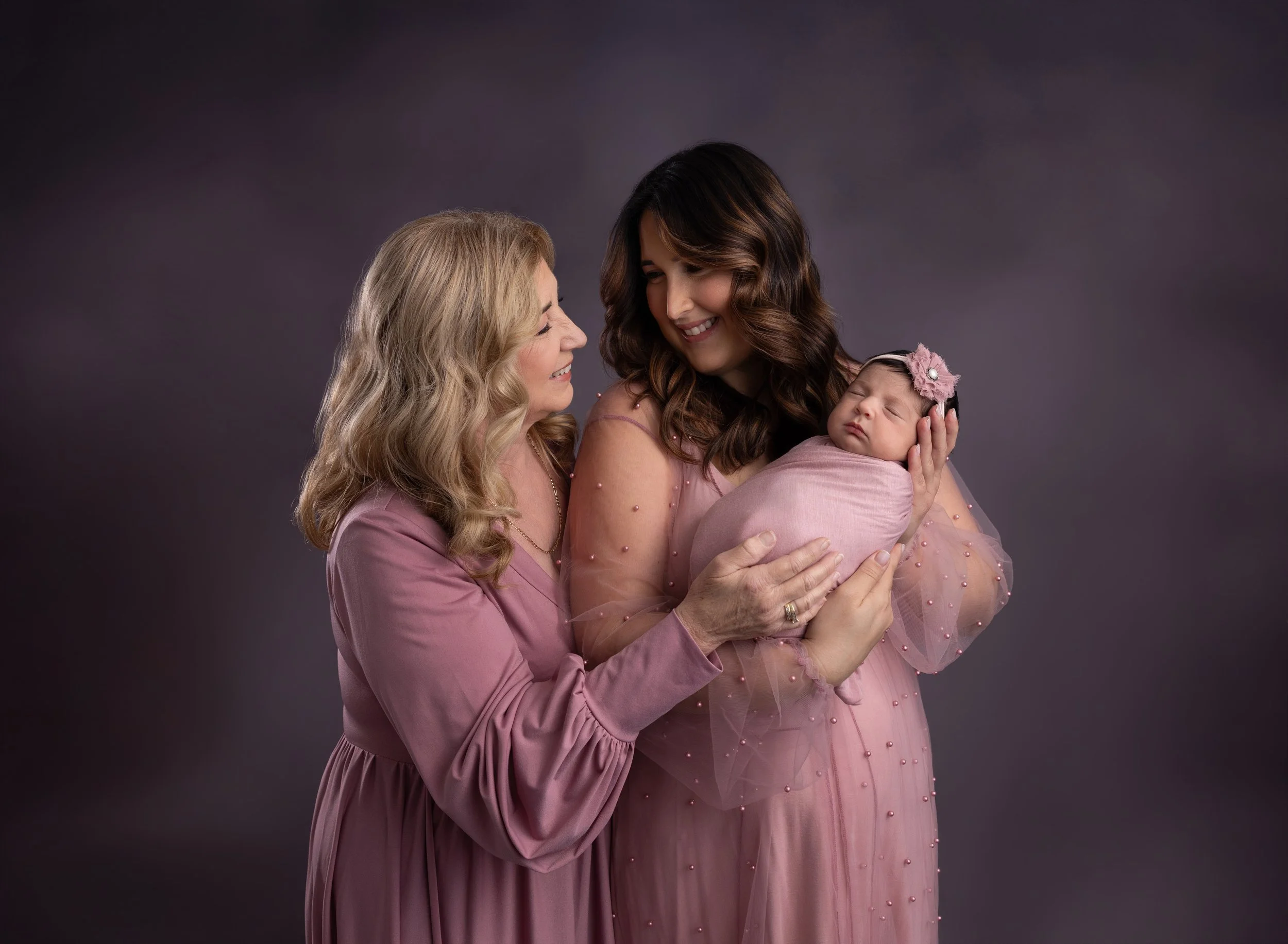 Newborn, mom, and grandma in pink Port Charlotte studio
