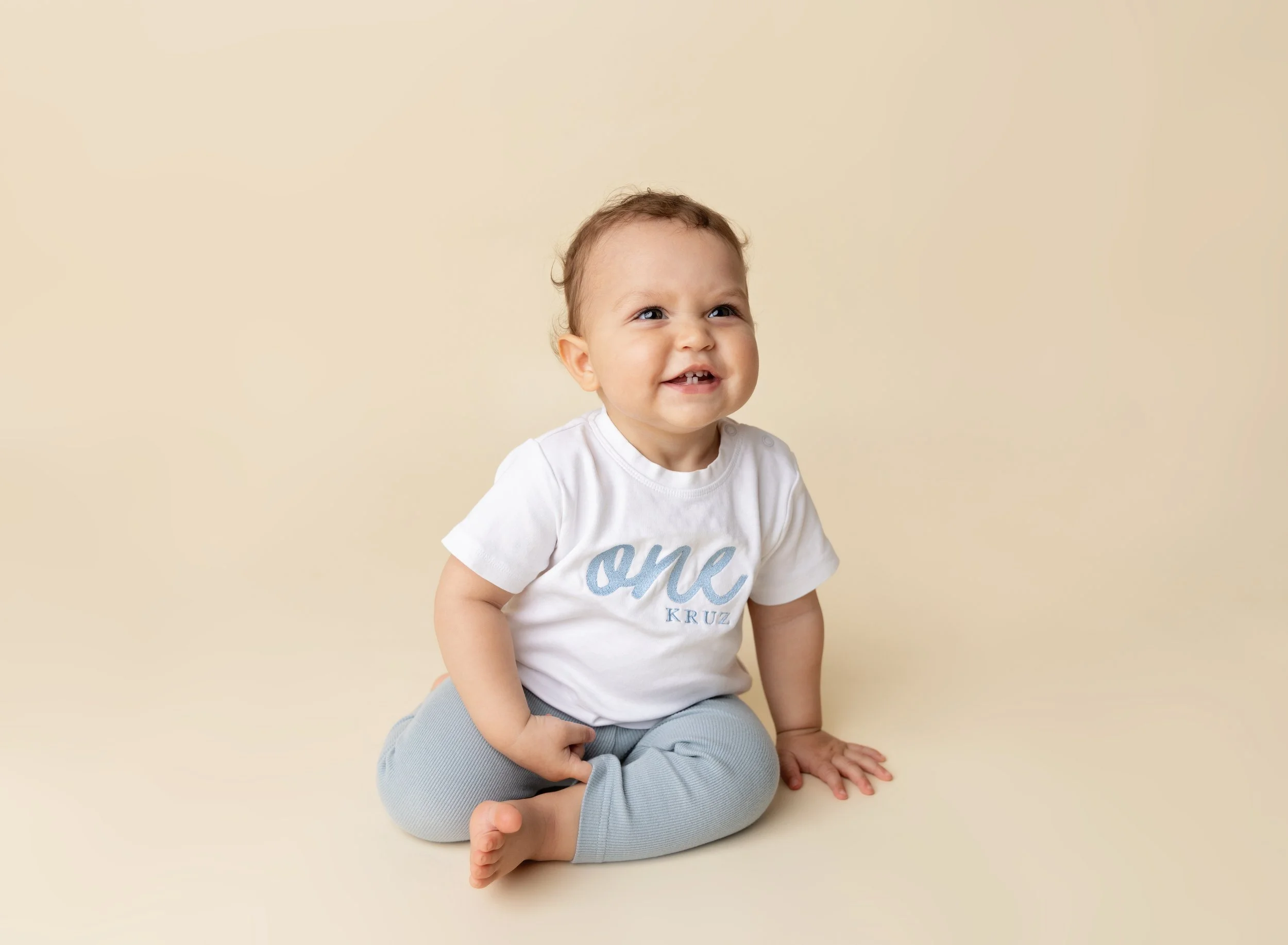 First birthday photo session boy on cream backdrop in Port Charlotte FL photo studio.