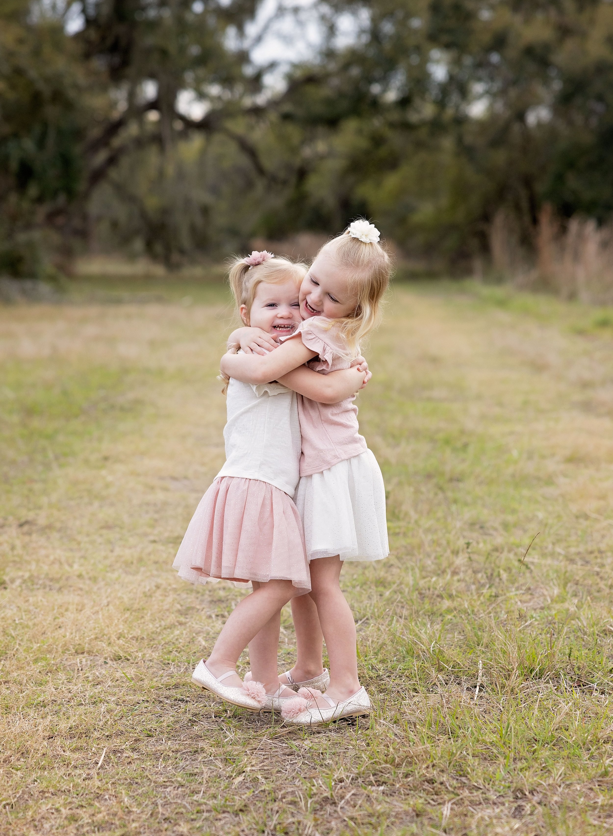 Sisters hugging in the park Port Charlotte FL