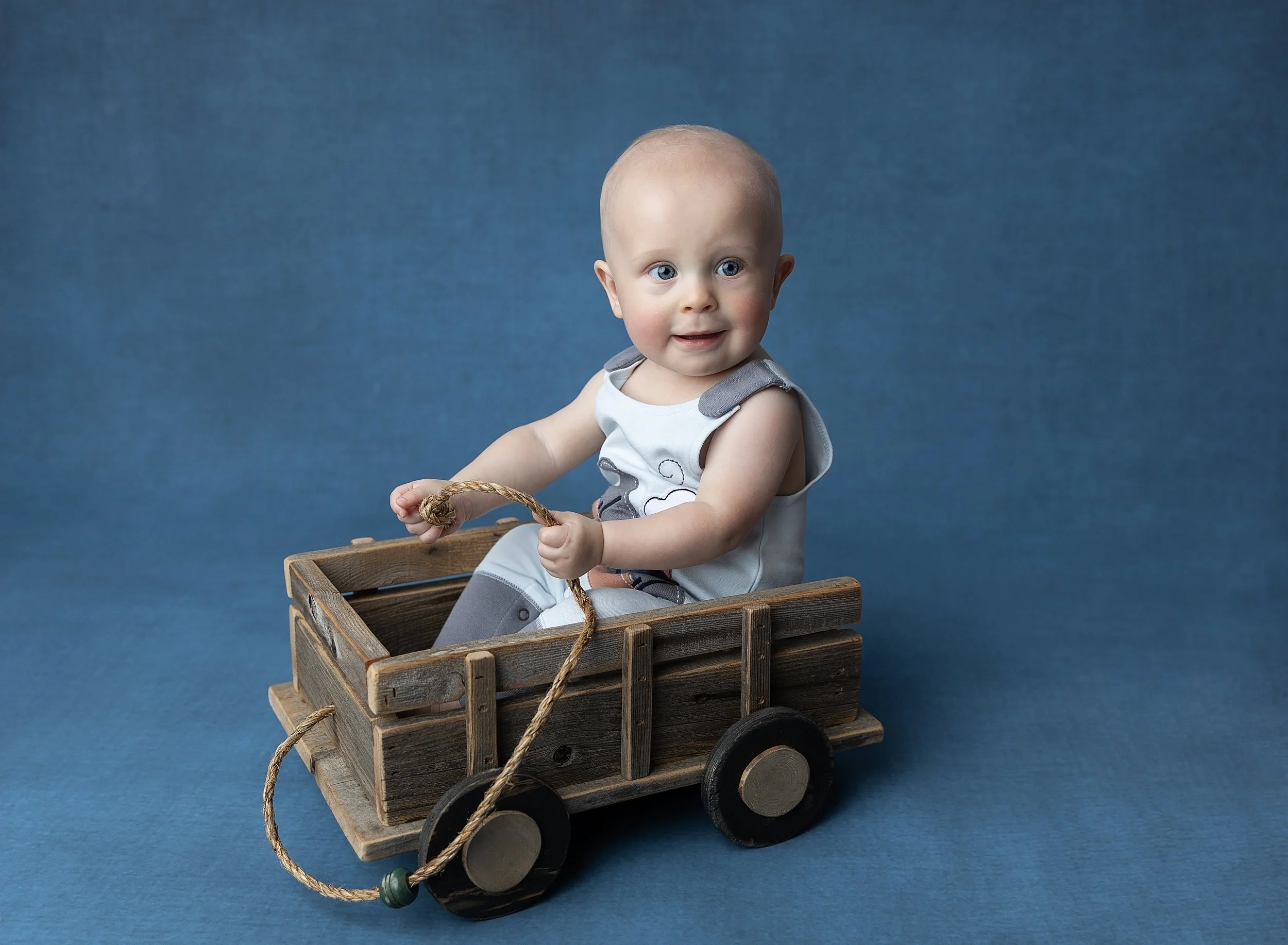 Seven month old boy in wagon in North Port photo studio