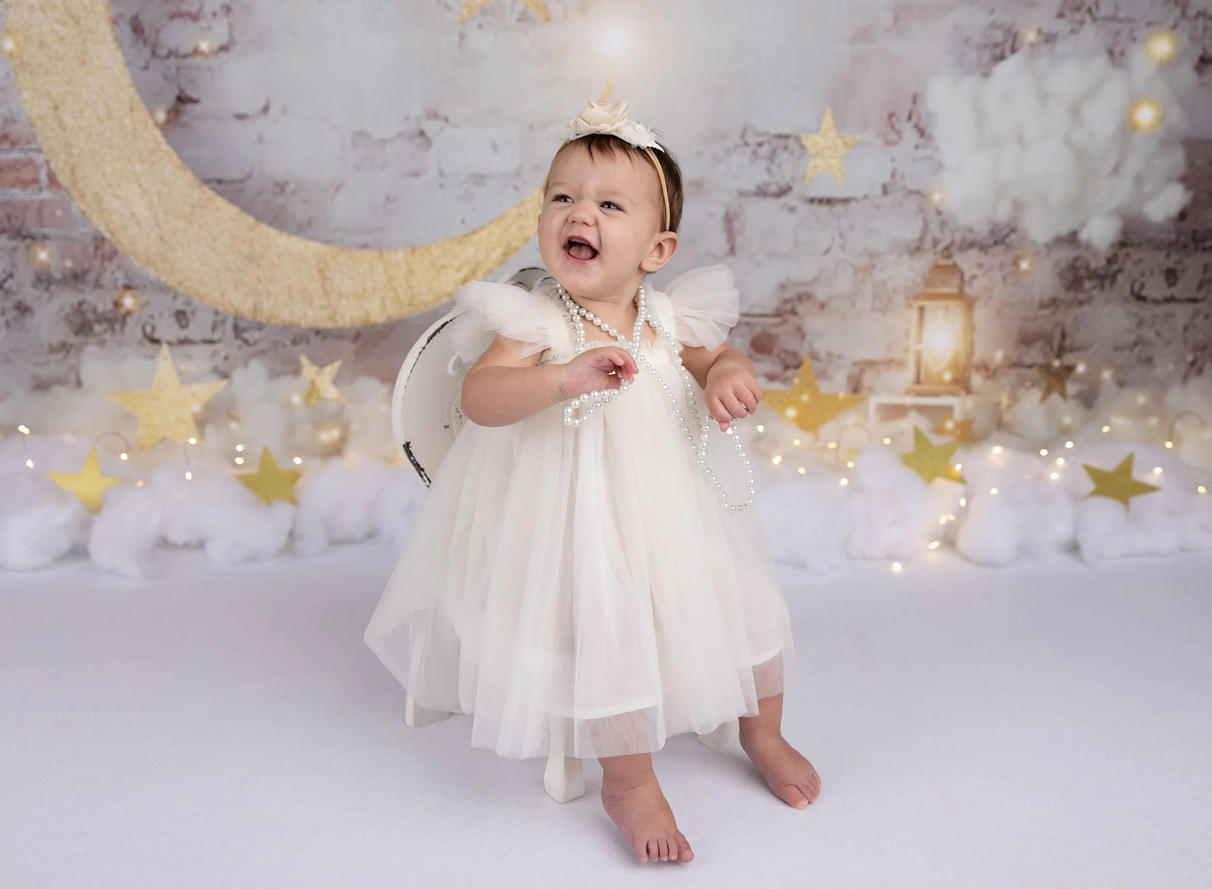 First birthday photo session with moon and stars theme in North Port FL photo studio.