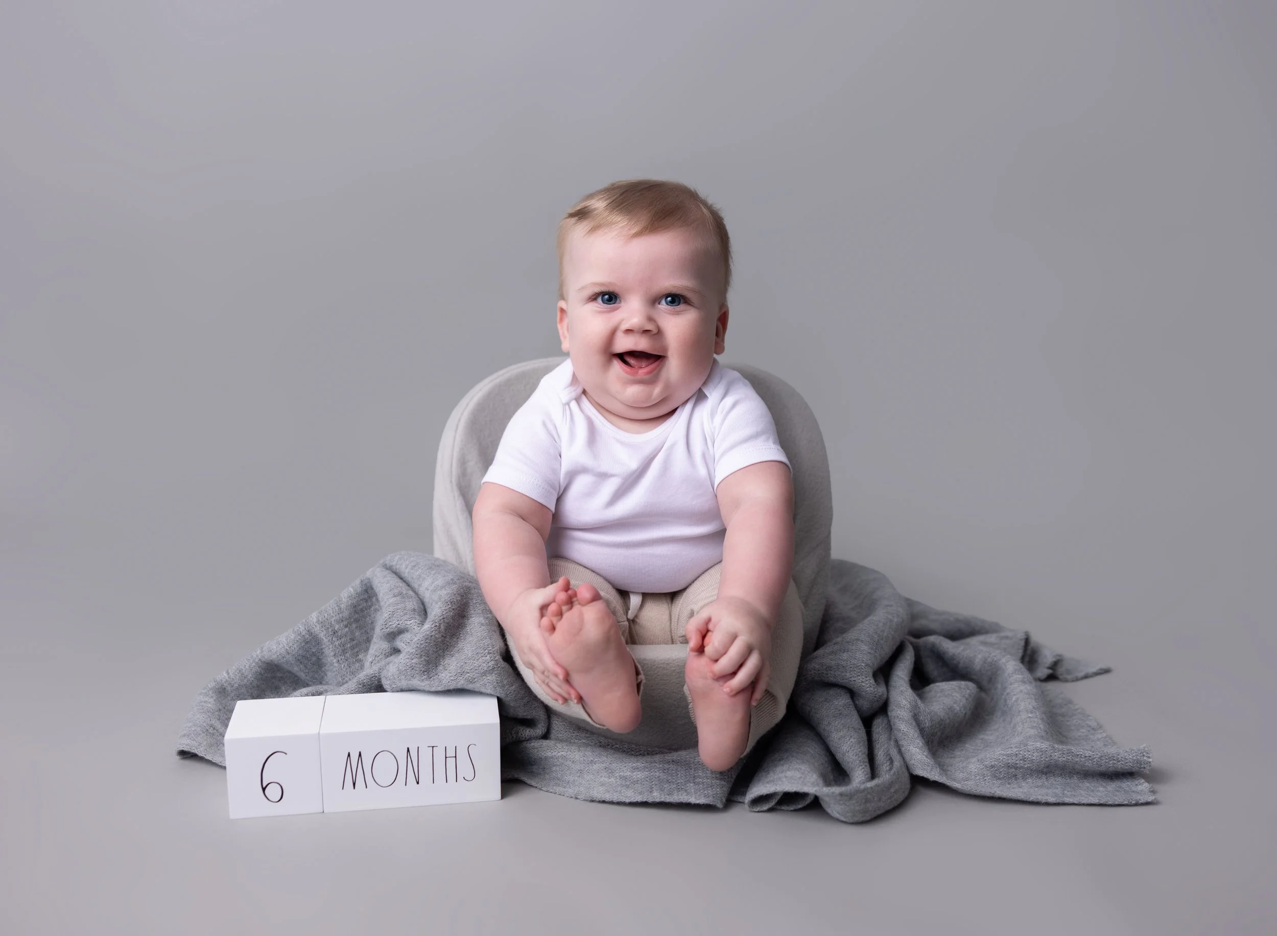 Six month old boy in grey in North Port photo studio
