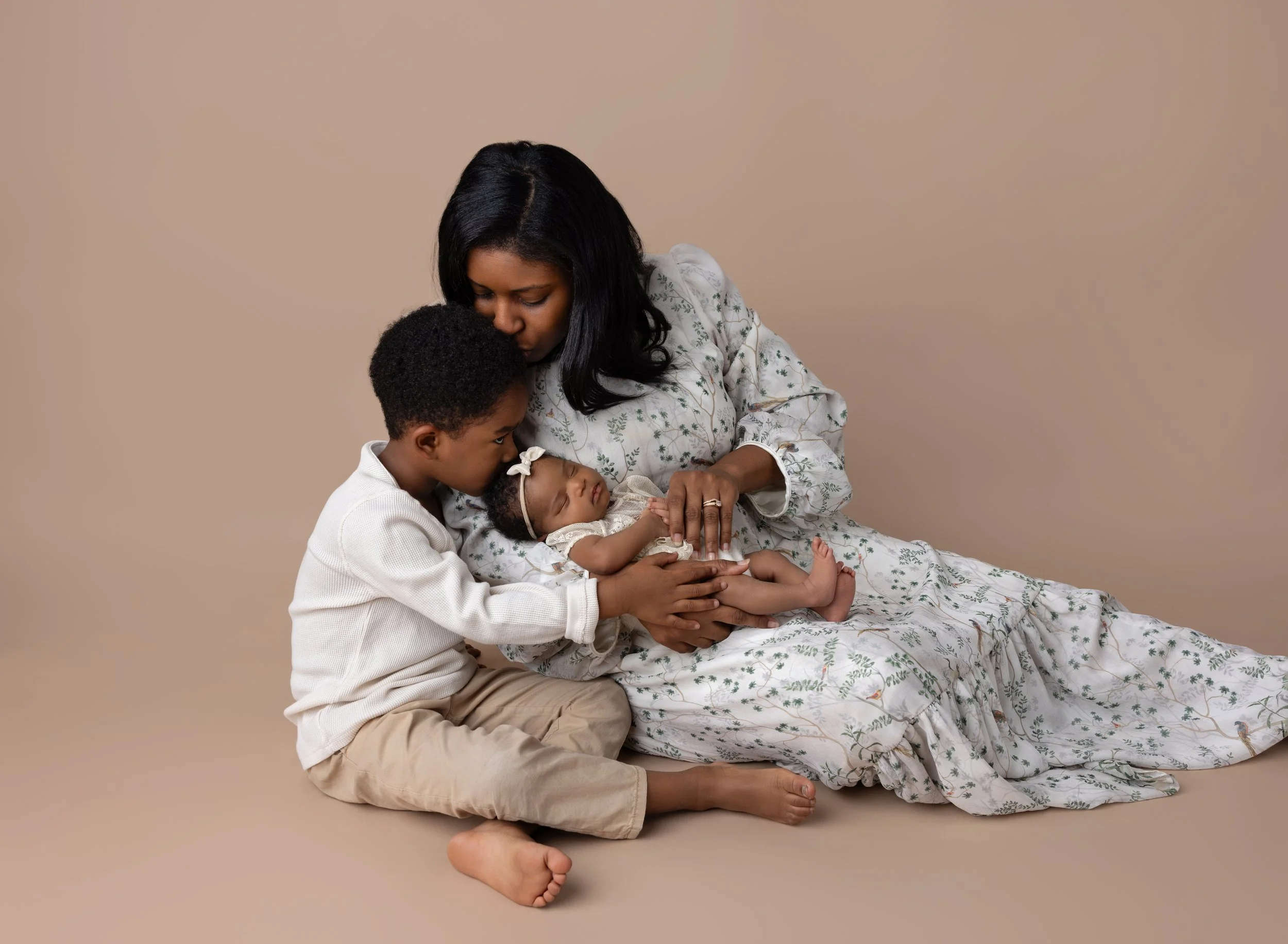 Newborn, mom, and brother in cream Cape Coral studio