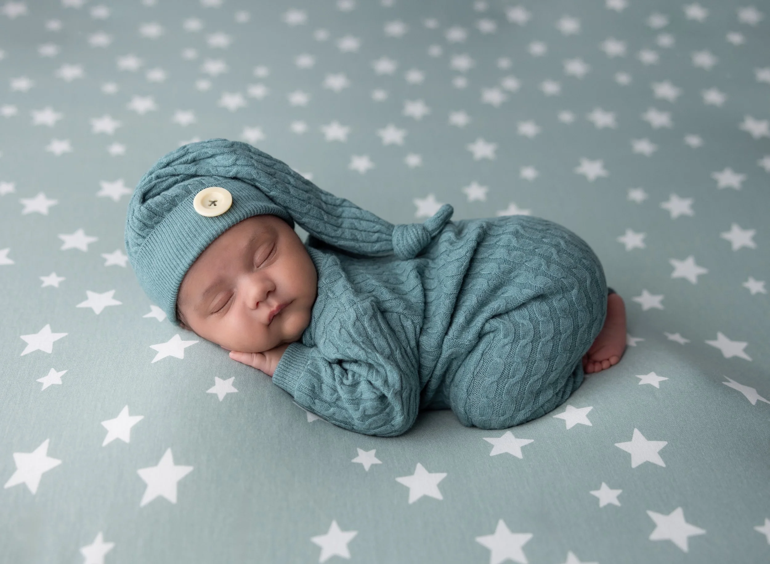 Baby boy in sage outfit on star blanket in North Port FL photo studio